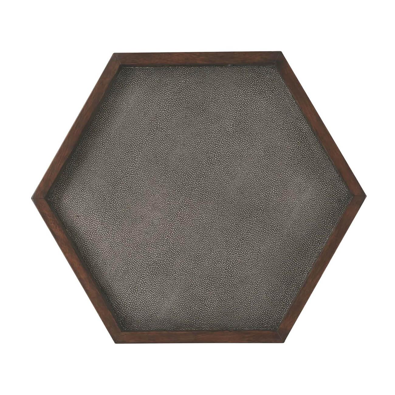 A Moroccan style faux shagreen wrapped hexagonal side table with pierced handle tray top, shagreen embossed leather sides, and a polished wood edge with keyhole form arches around the sides.

Dimensions: 23
