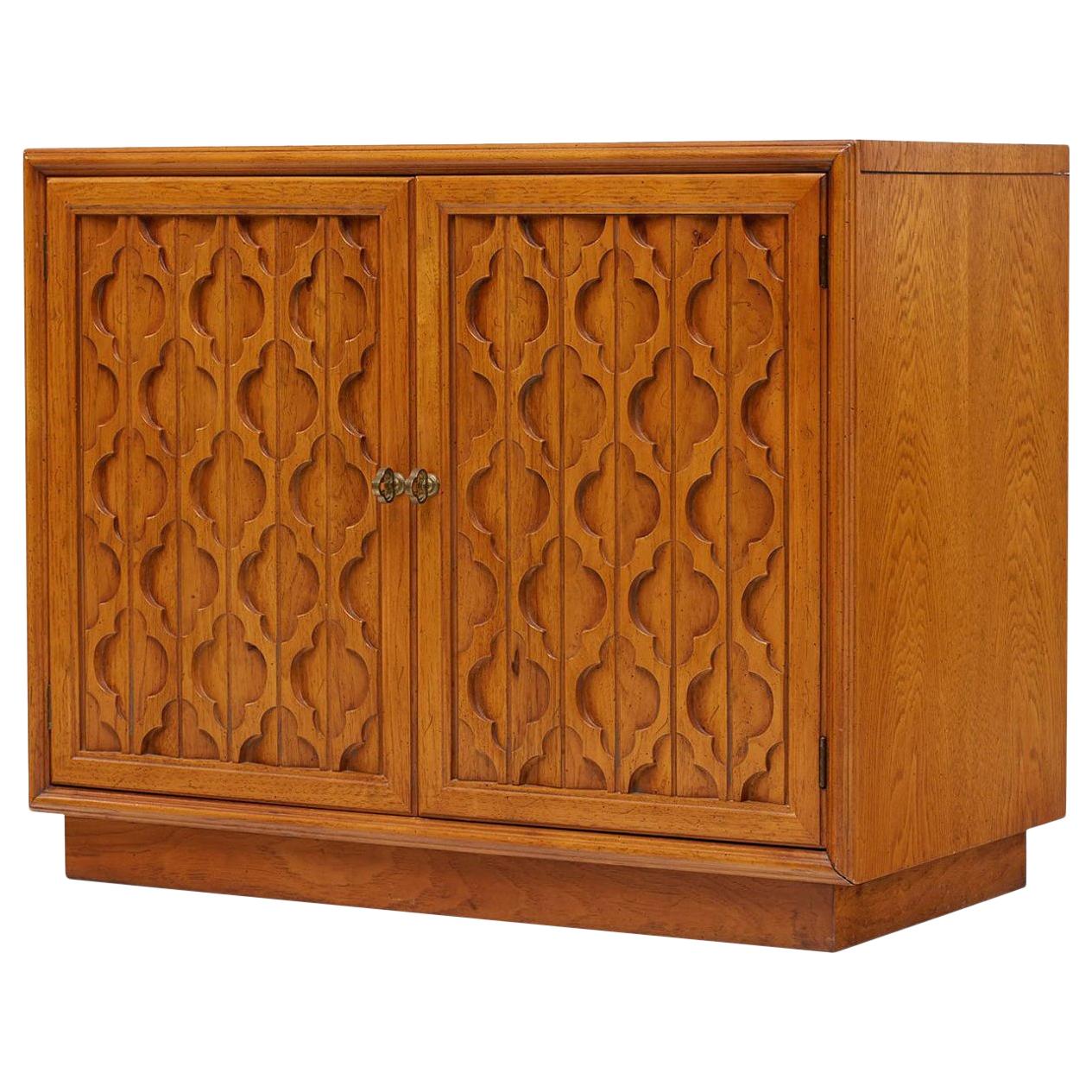 This midcentury Hollywood Regency Moroccan style heritage furniture commode cabinet would be perfect in nearly any room. Display in living room as an end table, bedroom as a nightstand or dining room as a buffet or bar cabinet.

Made by the