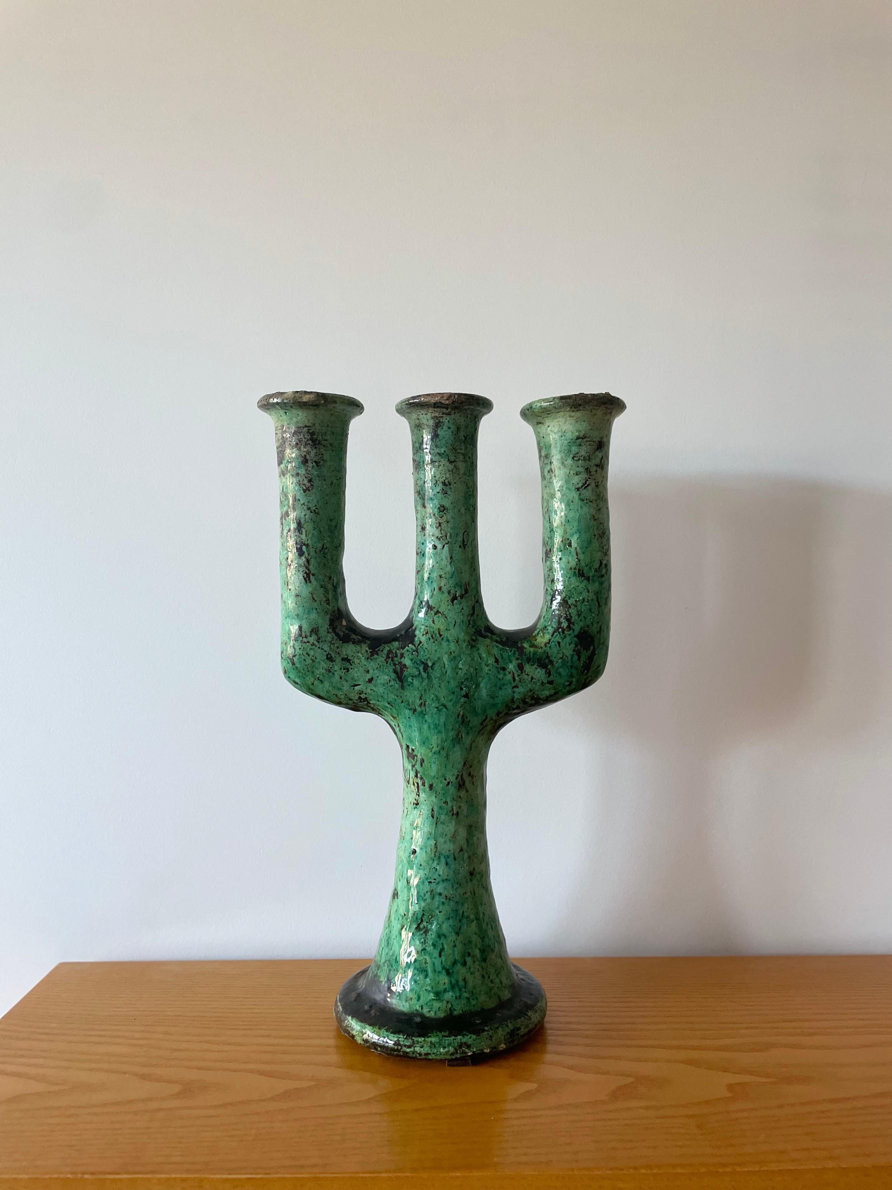 Moroccan Tamegroute Ceramic Candlestick in the style of Giacometti

This vintage handcrafted green enameled candlestick is a mere sculpture from Southern Moroccan village of Tamegroute, where skilled potters have practiced local techniques that have