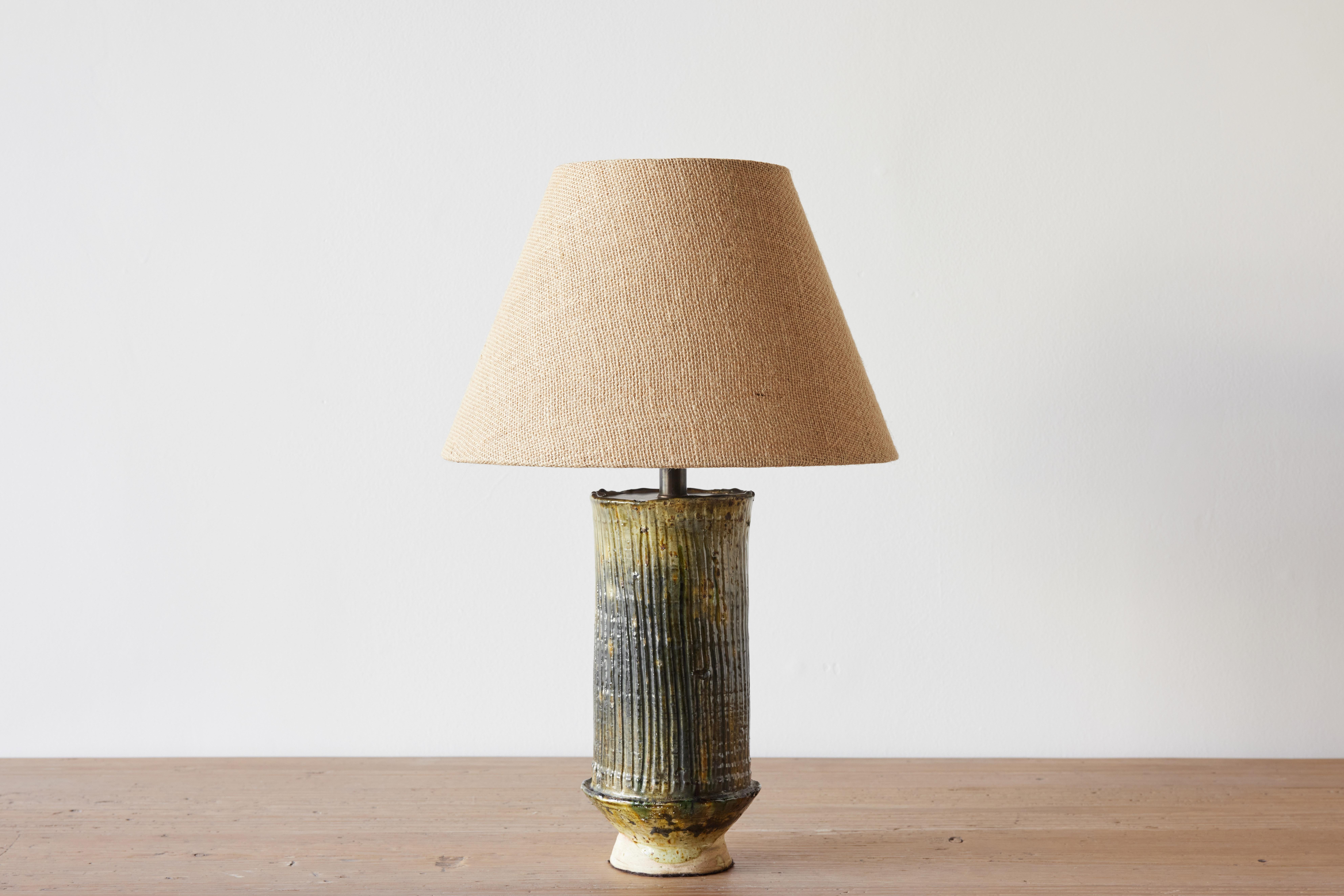 This handcrafted lamp base is from the Southern Moroccan village of Tamegroute, where skilled potters practice local techniques that have been passed down through generations. The characteristic green glazes, ranging from earthy olives to vivid