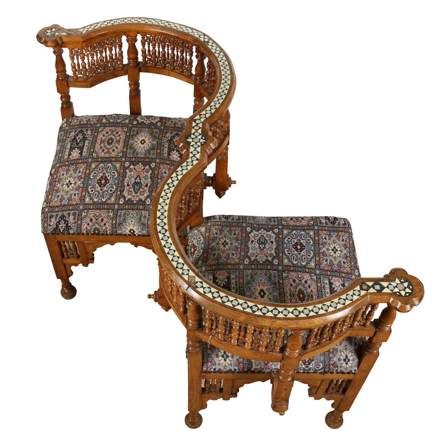 Moroccan tete-a-tete chair with inlaid and carved wood design and upholstered seats.