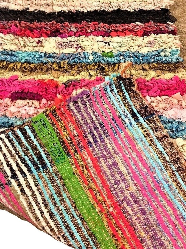Moroccan Tribal Boho Chic rug in multi-colors
This Boucherouite rug is a unique piece handmade by women in Marrakesh and in the Atlas Mountains area. This a vintage style piece with humble beginnings as fabric scraps is transformed into beautiful