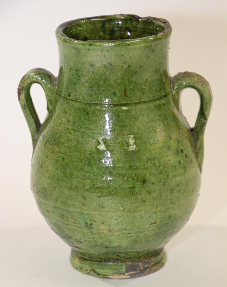 Moroccan Berber green glazed decorative terra cotta jar with handles.
Wonderful green and brown shimmering ceramic pottery that can be found only in south Morocco in the village of Tamgroute..
These vintage Moroccan tribal handcrafted green