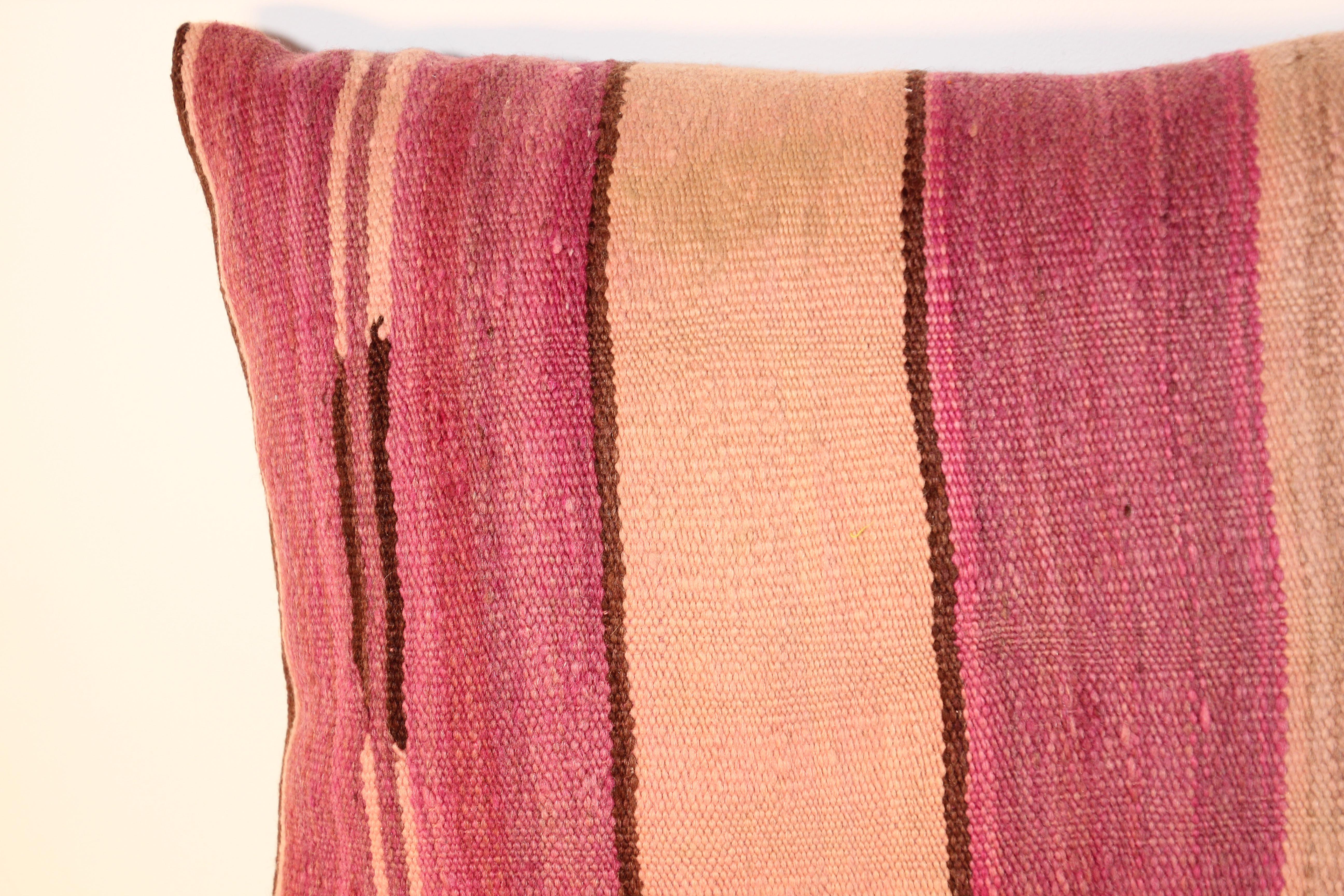 Custom Berber lumbar pillow cut from a vintage handwoven wool Moroccan tribal flat-weave Kilim tribal rug.
Handwoven by the Berber women from the Atlas Mountains of Morocco.
Great handcrafted textile with earth tone colors large stripes in purple,