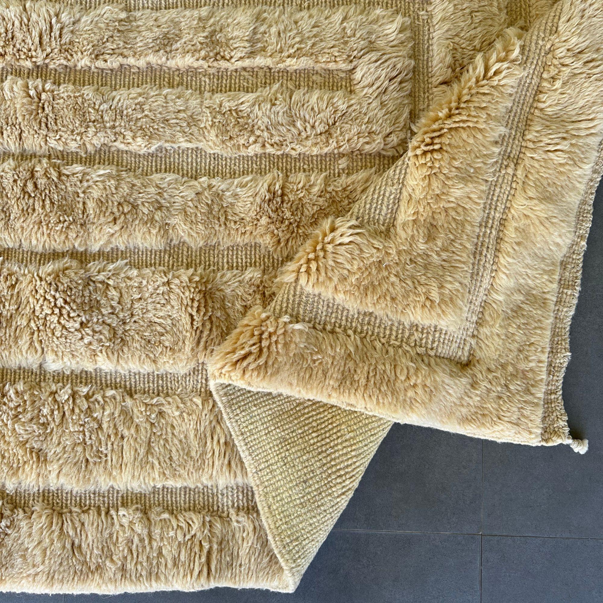 Introducing the Serene Serenade, an exquisite Moroccan tribal rug that exudes tranquility and elegance. This beautiful rug features a calming creme color with a textured design, meticulously handwoven by skilled Berber artisans. The Serene Serenade