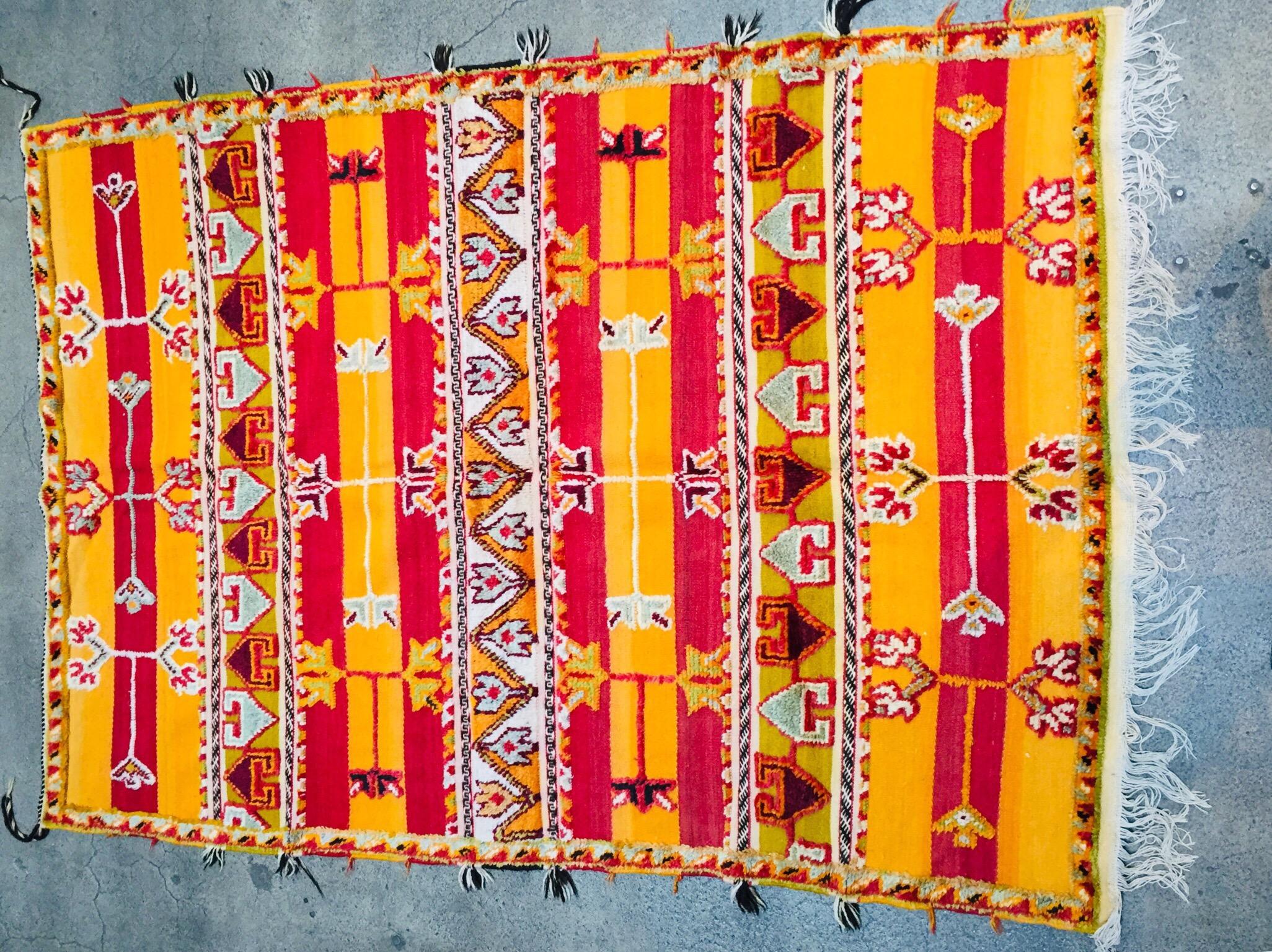 Moroccan vintage tribal rug, handwoven by Berber women in Morocco.
Great mix of organic wool and cotton in hearth colors with flat-weaves and pile wool mixed weaves.
This kind of rug is typical of the Glaoui tribes of Morocco.
Great North African