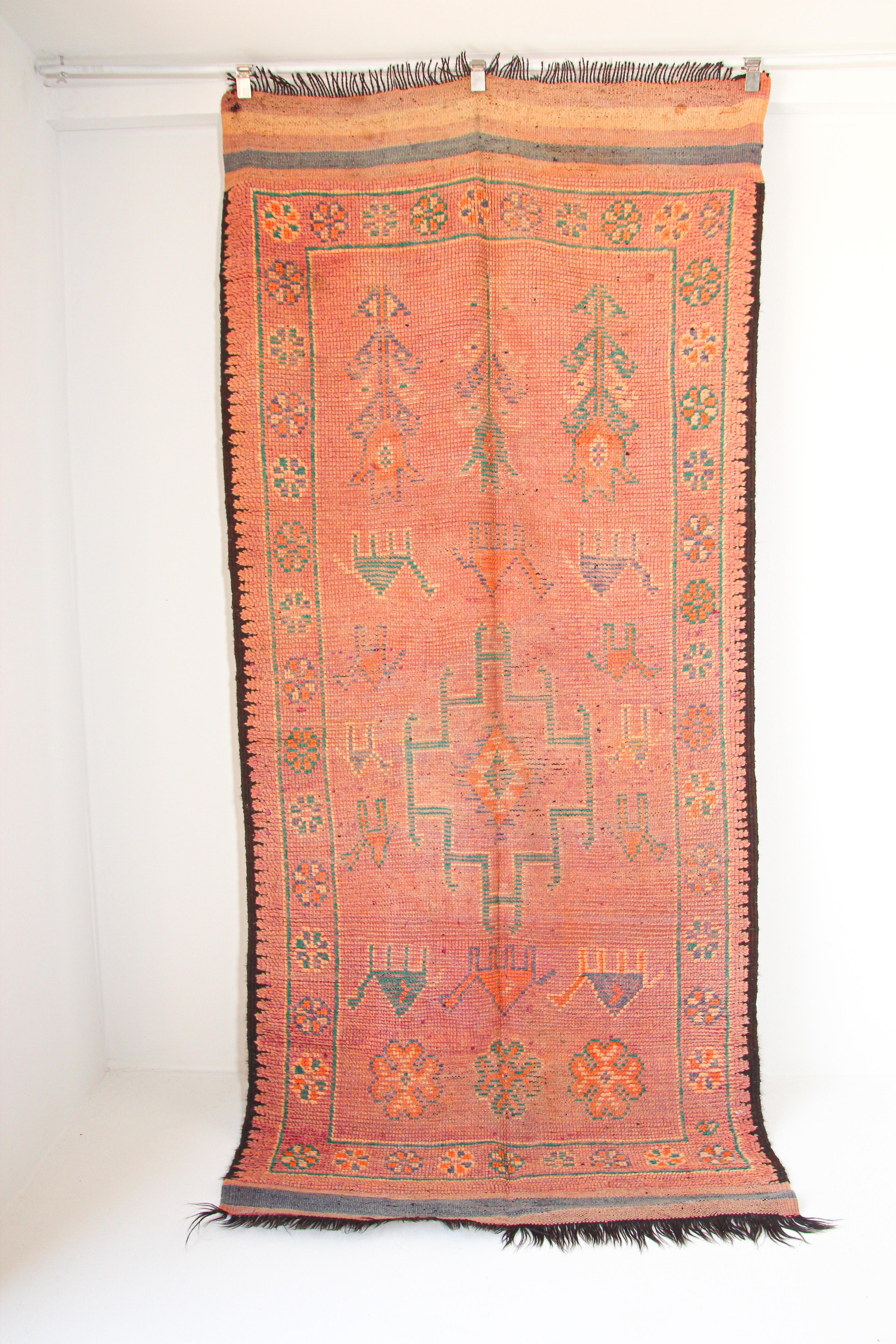 1960s authentic handwoven vintage Moroccan Berber tribal rug, nicely aged and faded orange washed cors.Handwoven by The Berber tribes in Morocco with traditional geometric tribal designs.South of Marrakech low pile rug runner.Great to add accent to