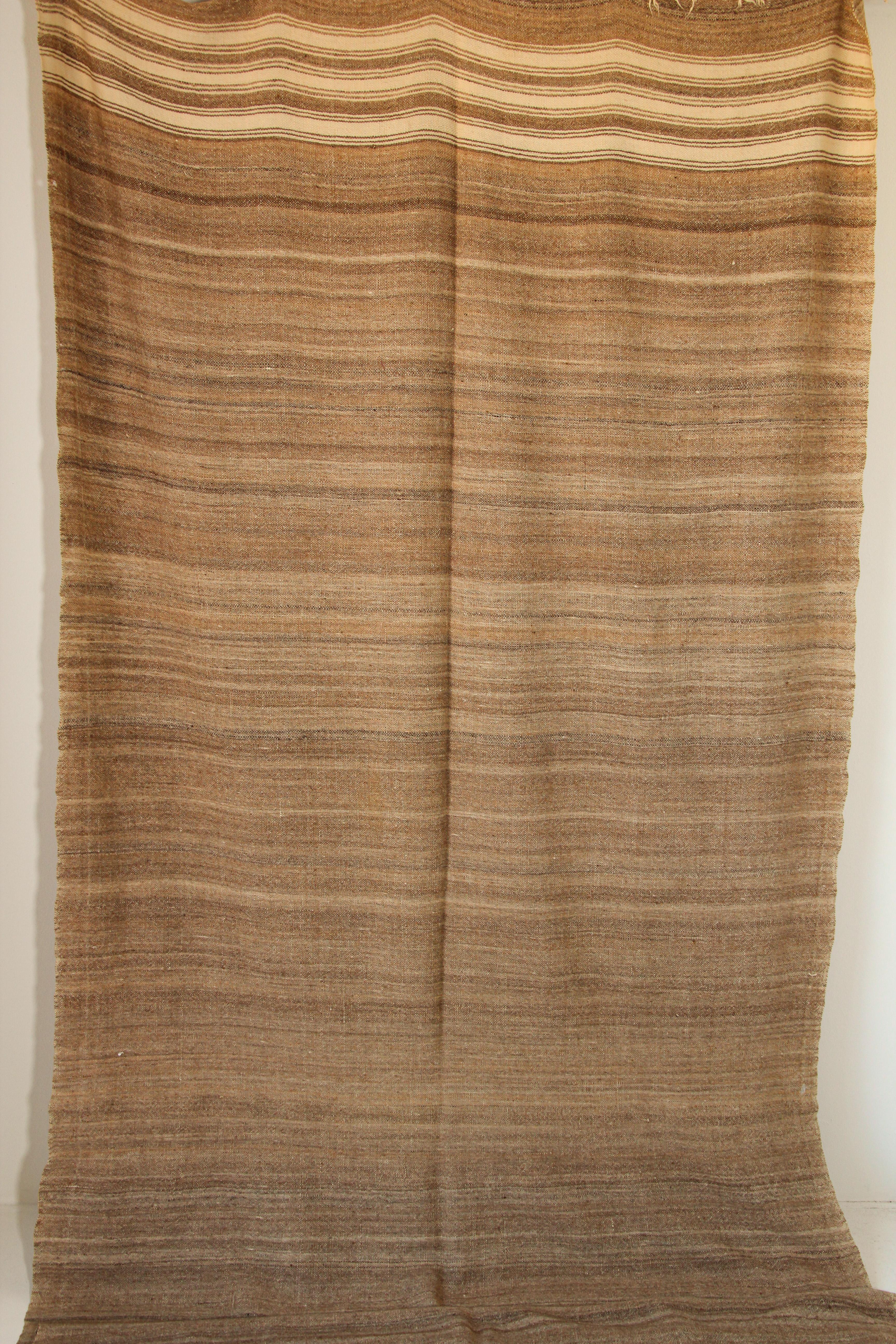 1960s Vintage Moroccan rug flat-weave tribal brown Kilim or blanket.Large size blanket vintage Moroccan rug, handwoven by Berber women in Morocco for their own use.This rug was made using flat-weave technique with linear pattern of alternating