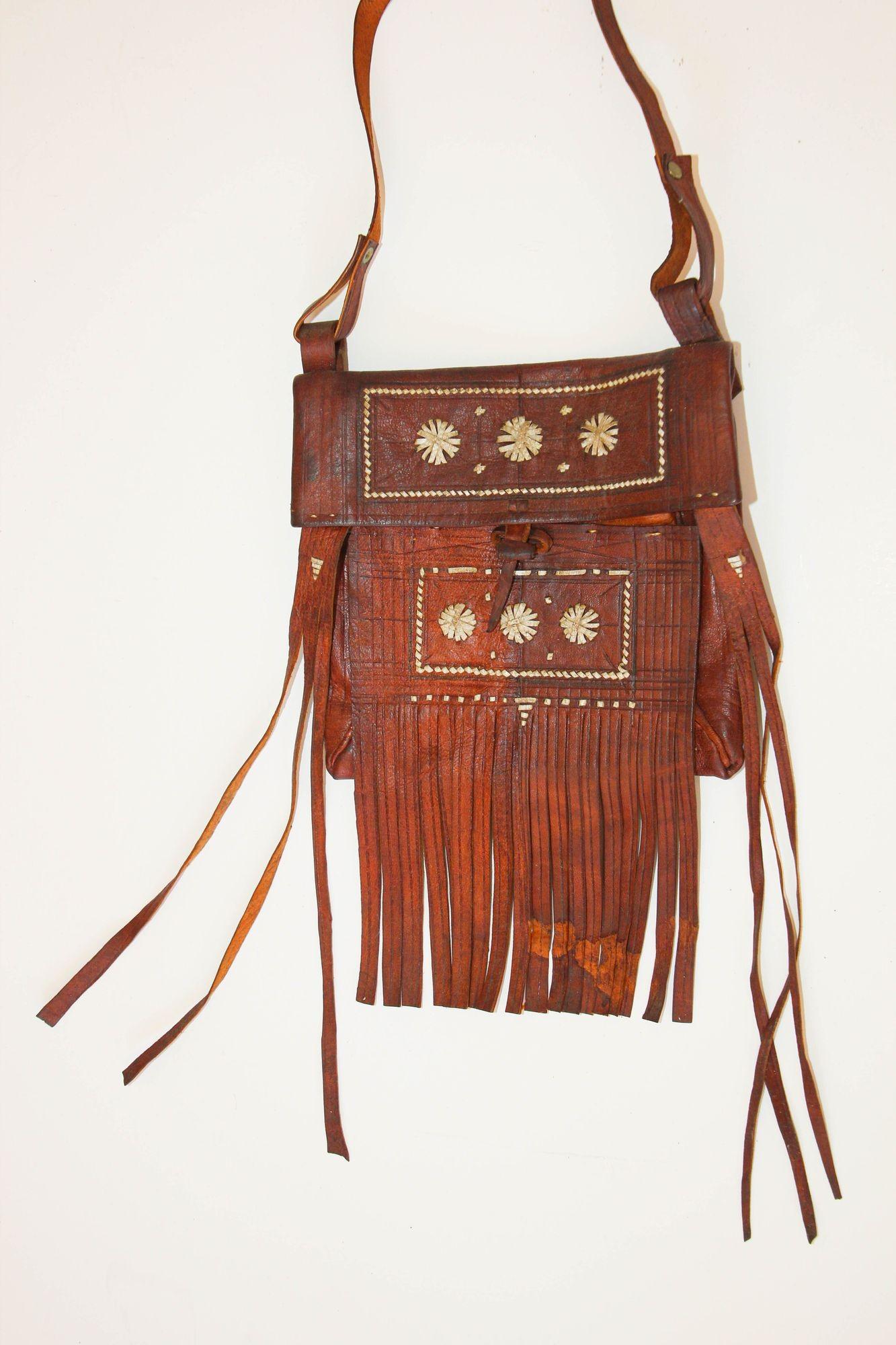 Vintage African Moroccan leather handcrafted Tuareg bag with fringes. Wall decorative Art.
Collectible vintage Real work of art hand made by the Berber tribes of Morocco.
Tightly hand woven colorful leather strips make up an intricate geometric