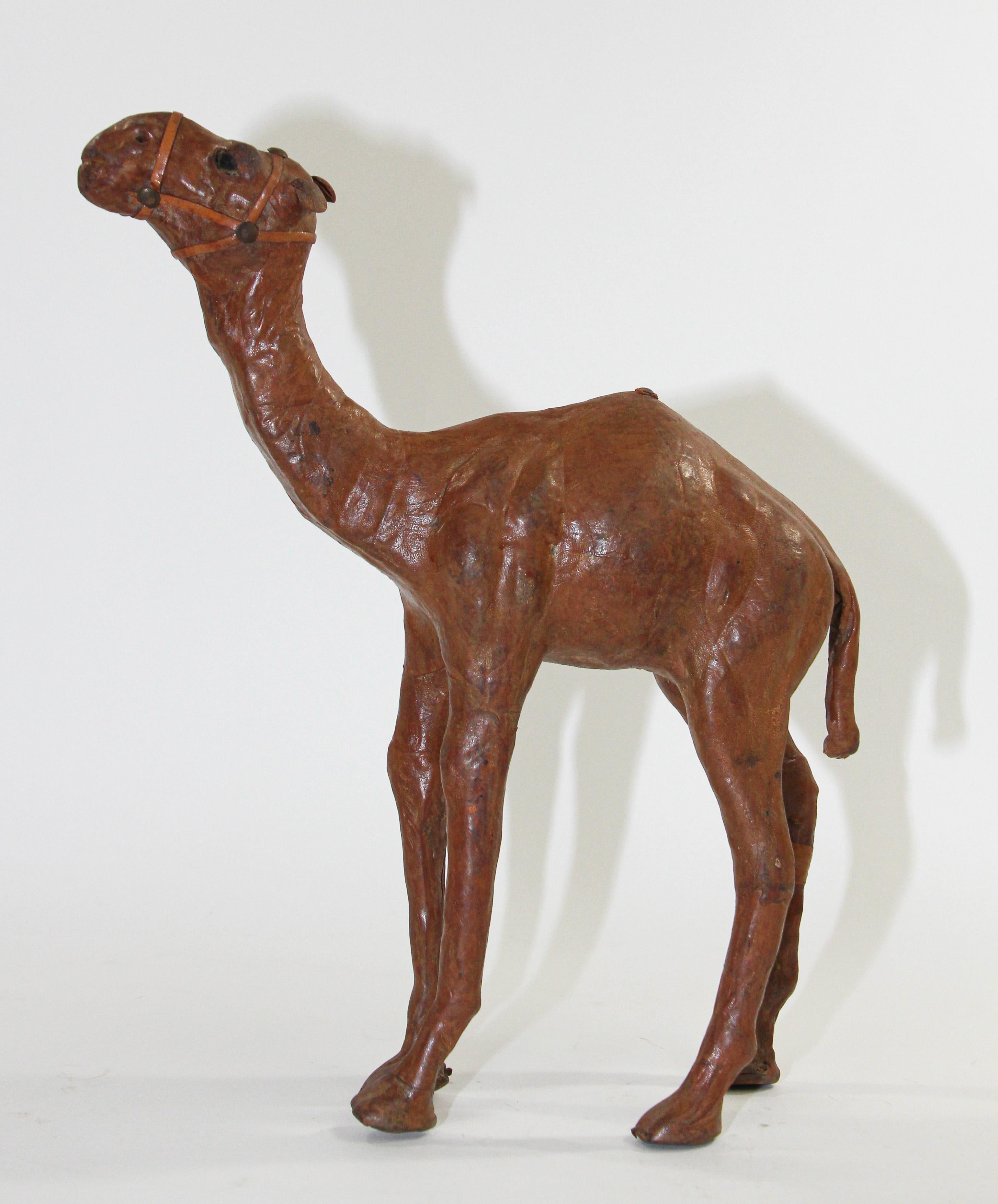 Vintage handcrafted leather wrapped standing camel
Leather wrapped Moroccan camel sculpture. 
From the 1970s, handmade in excellent vintage condition. 
Brown camel color leather, nicely done, leather has aged beautifully. 
Hand crafted in