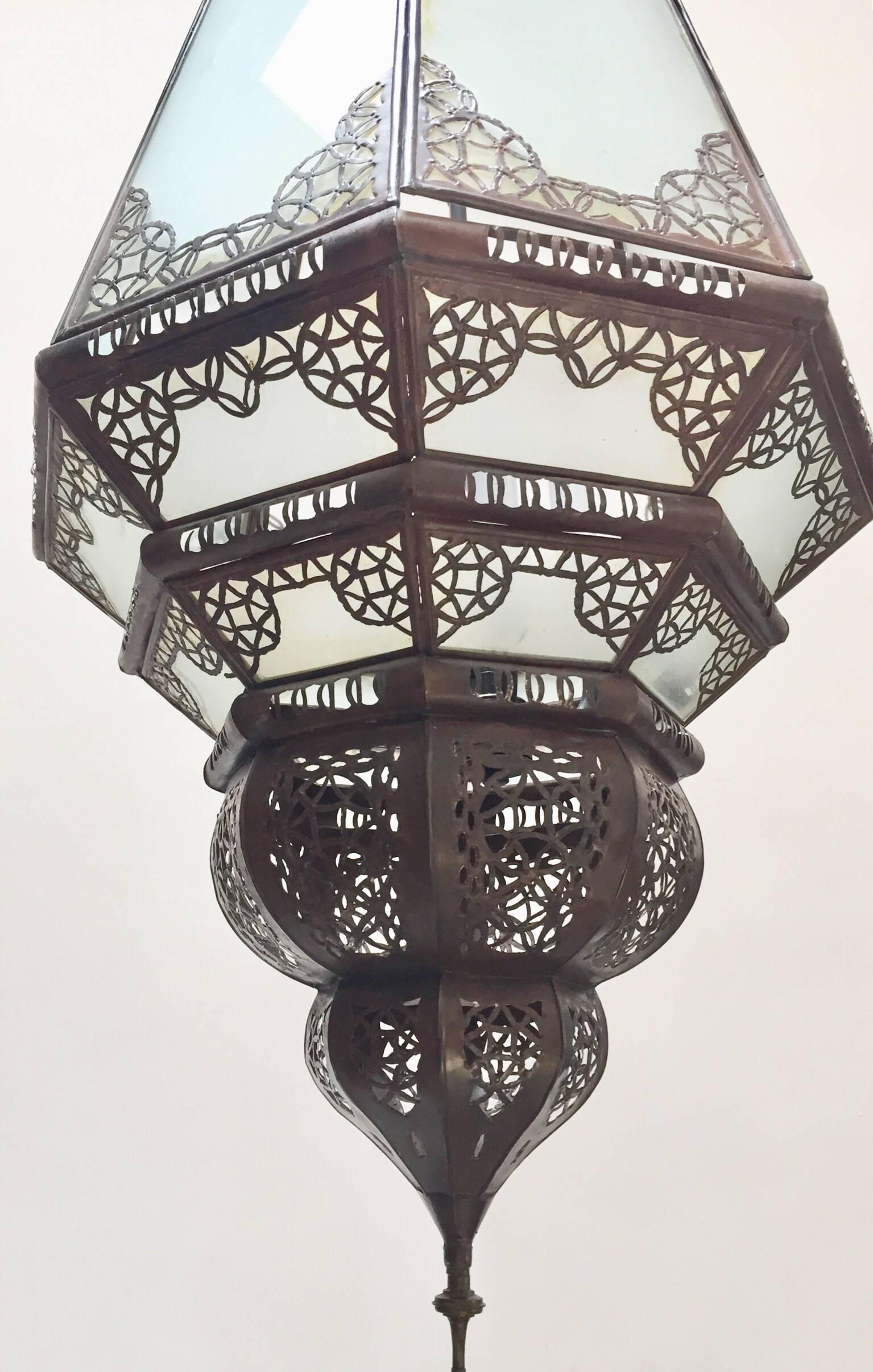 Great vintage Moroccan handcrafted frosted glass lantern.
The top and bottom metal hand-crafted in openwork Moorish design.
Rewired with a cluster of four lights.
Comes with 3 feet chains and canopy, chains could be adjusted to your