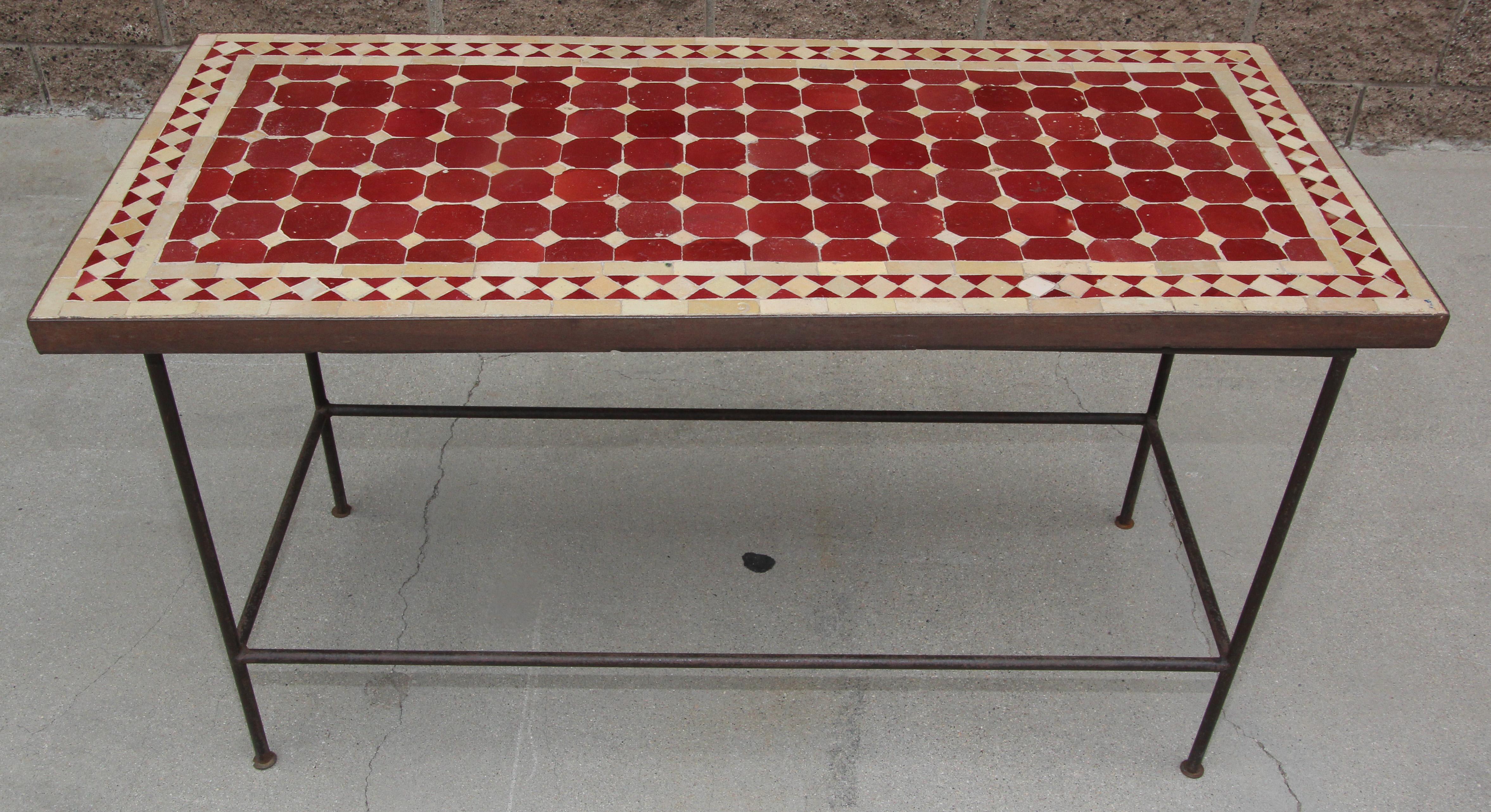 Handcrafted vintage mosaic tile tabletop, handmade using reclaimed Moroccan tiles in dark red color.
Moroccan mosaic side table, delicately handcrafted in fez with traditional glazed red tiles.
The handcrafted zellige tile table sits on a metal