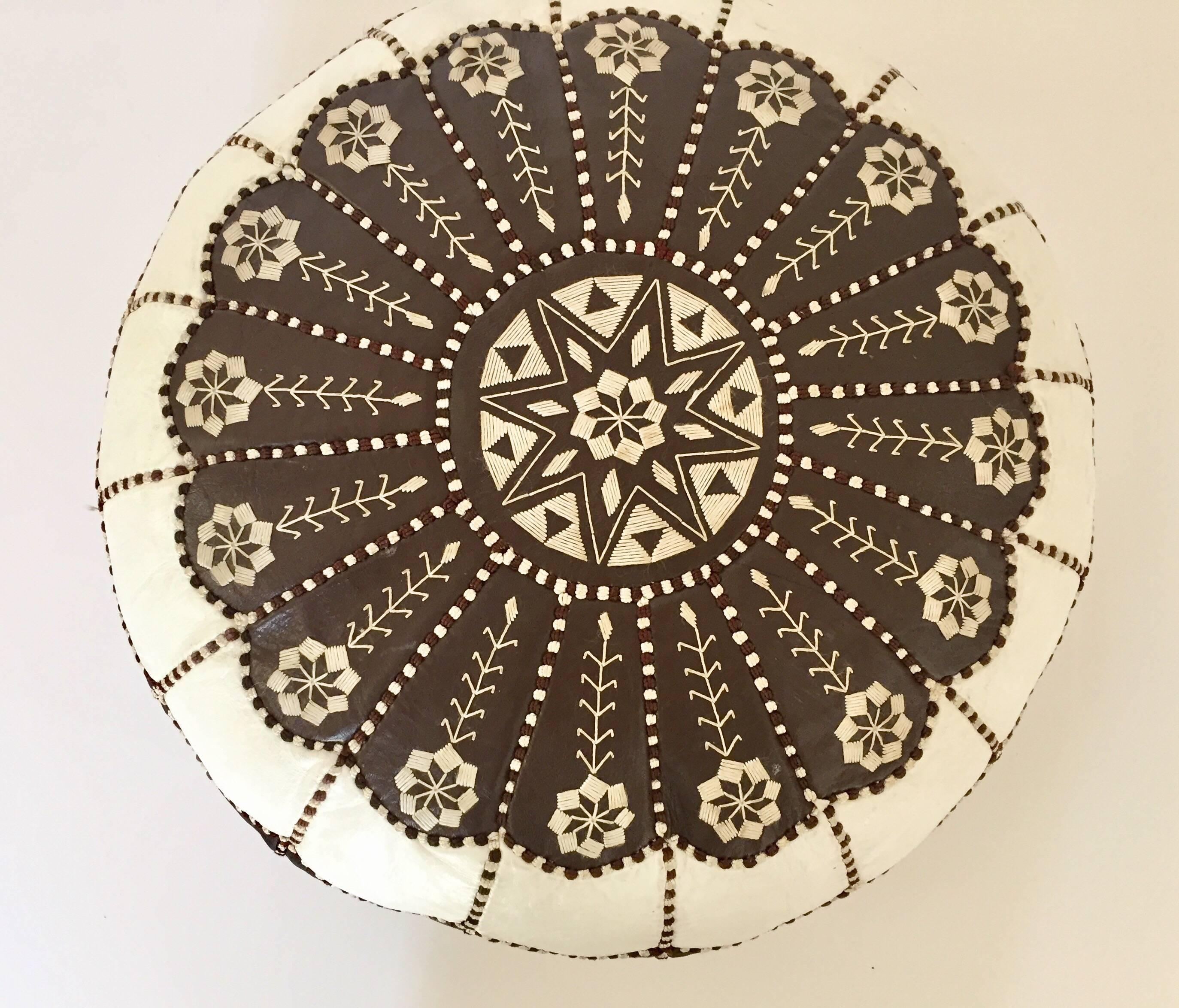 Vintage Moroccan white and brown colors round pouf hand tooled and embroidered in Marrakesh.
Beautiful geometrical designs are hand-stitched on this Moroccan stool by expert Artisan.
Use these round handcrafted poufs as ottoman or accent side