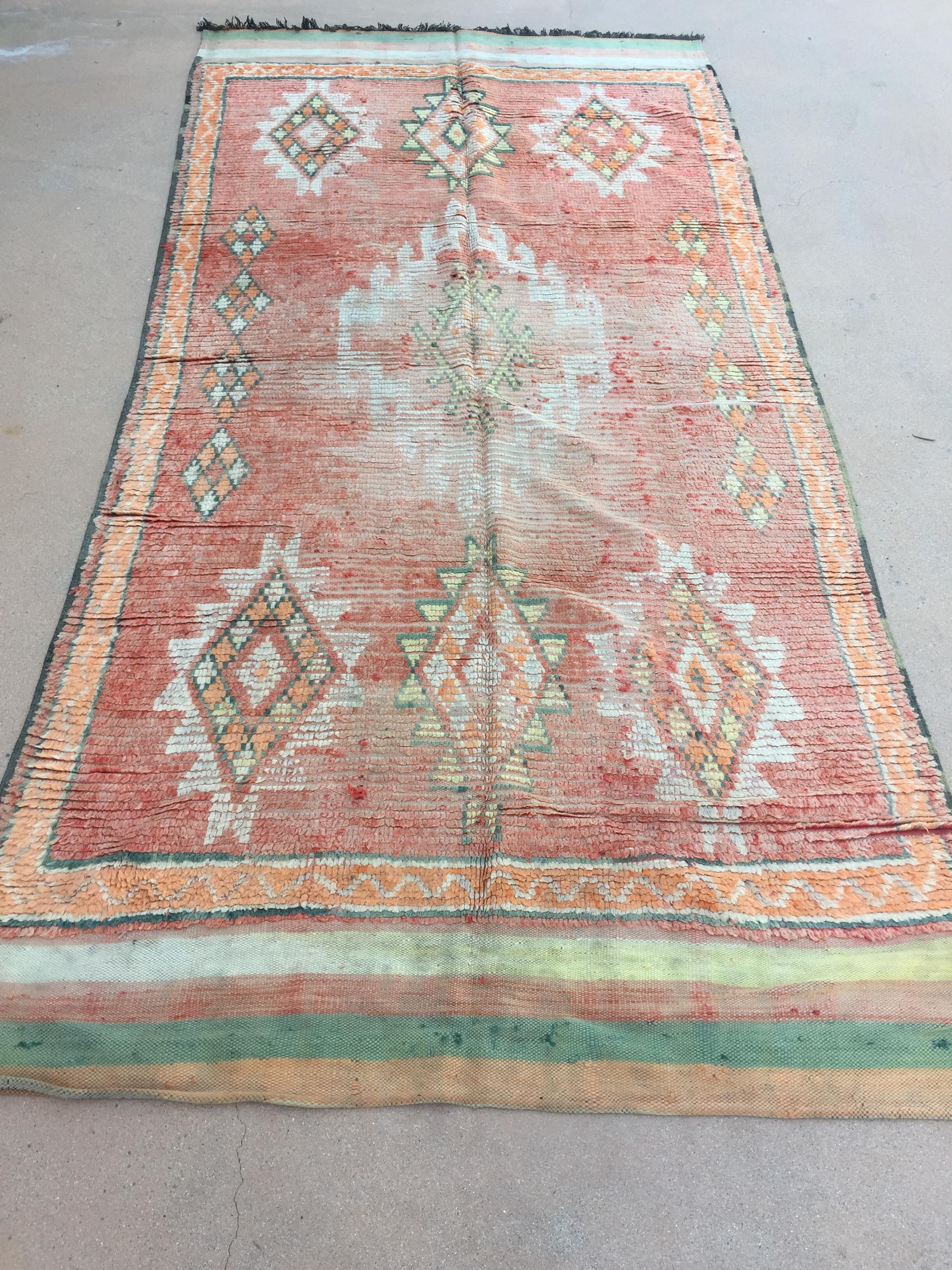 1960's Large handwoven vintage Moroccan Berber tribal rug, nicely aged and faded with pink and sage cors.Handwoven by The Berber tribes in Morocco with traditional geometric tribal designs.South of Marrakech low pile rug runner.Great to add accent