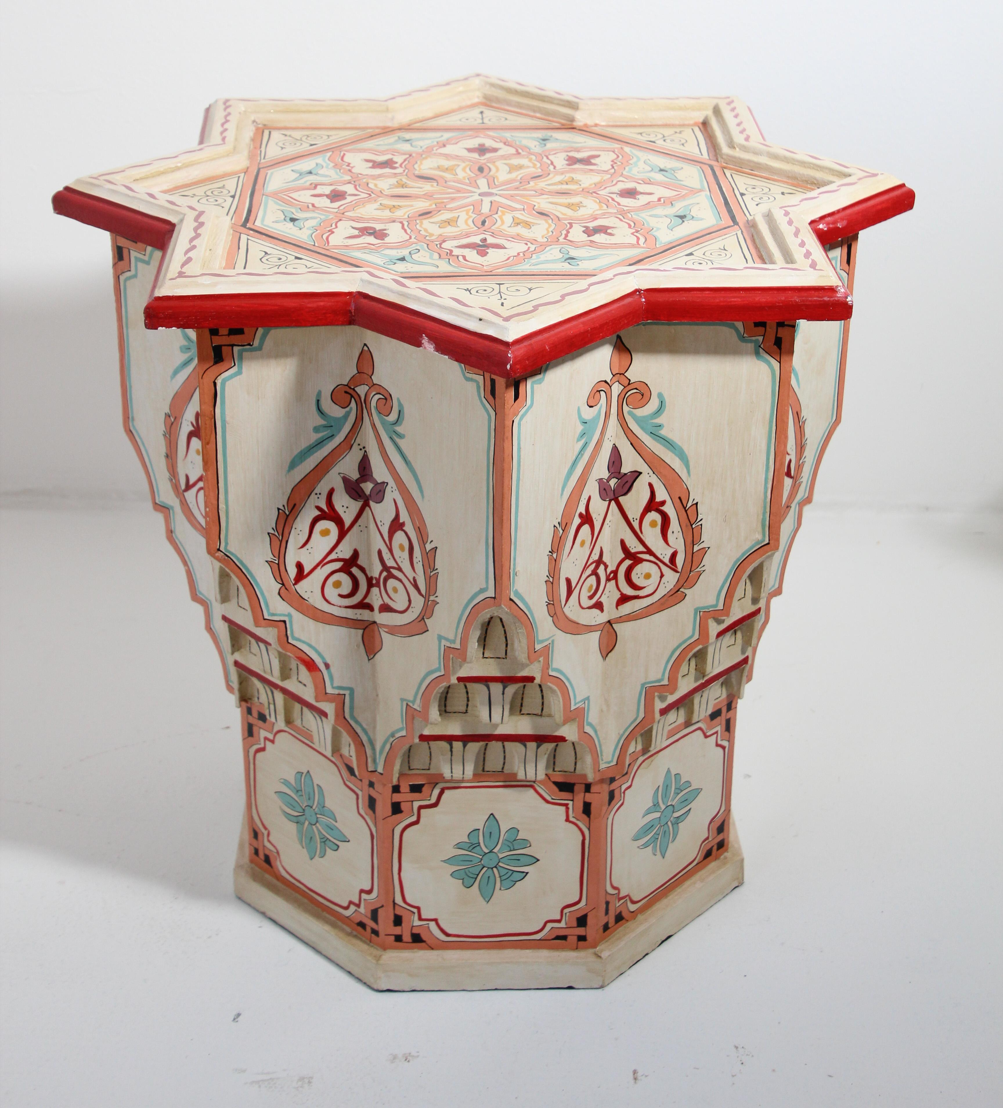 Moroccan colorful hand painted and carved side occasional white table with Moorish designs.
Pedestal table in vanilla, off white background with multicolored floral and geometric designs.
Very decorative fine artwork on a star shape top.
Hand