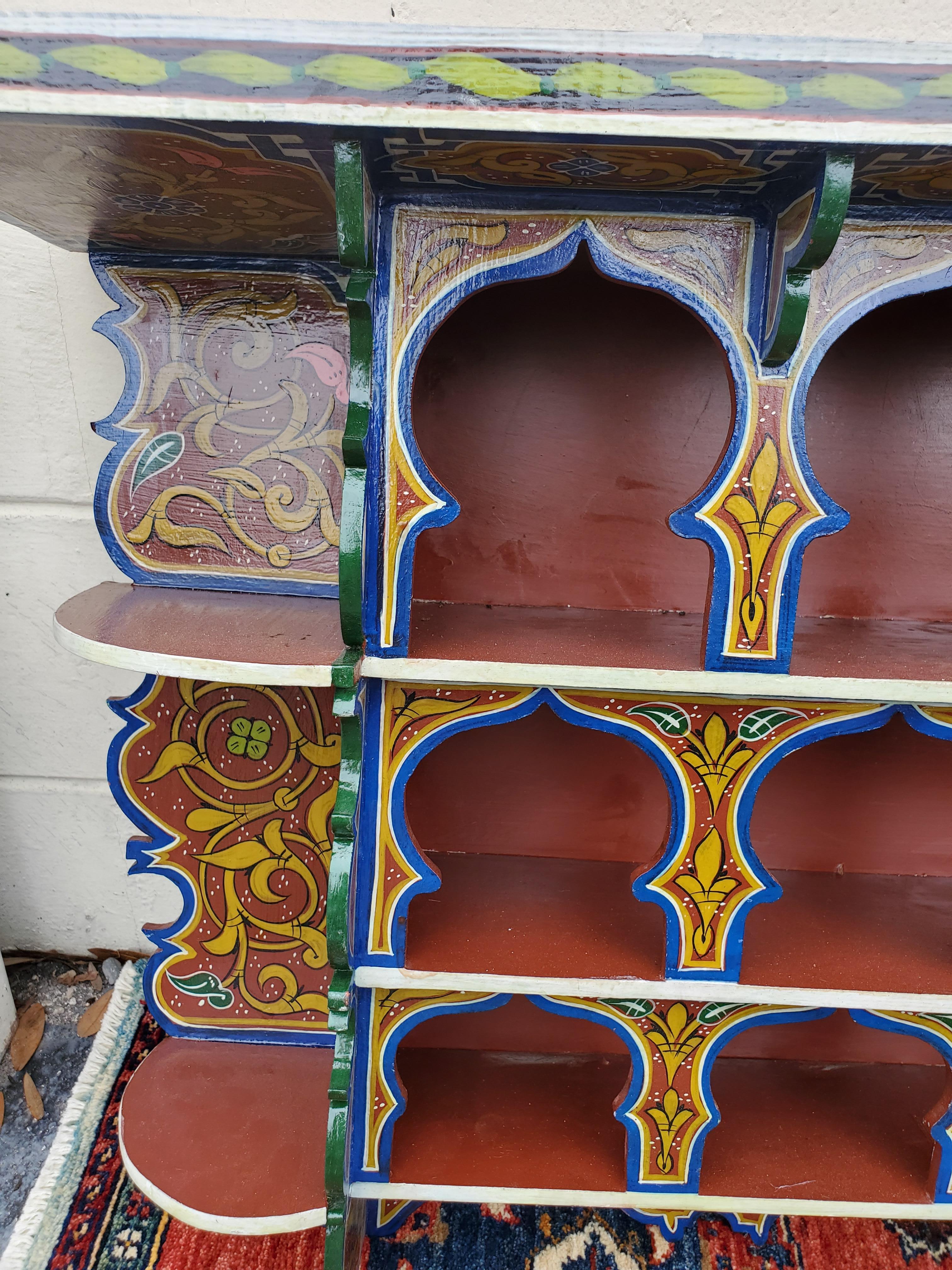 Amazingly hand carved and hand painted reclaimed wood wall shelf from Morocco. Long shape. Multi-color. Plenty of storage spots. Perfect for any home or office. This beautiful shelf can be easily mounted on your wall. No assembly necessary. Measures