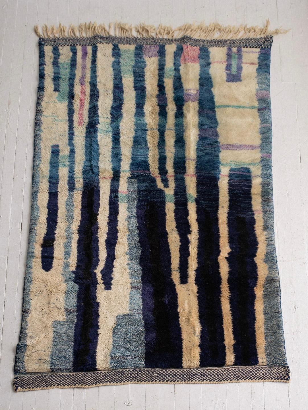 Hand knotted Moroccan wool rug. High pile shag. Graphic abstract pattern in shades of blue and cream.