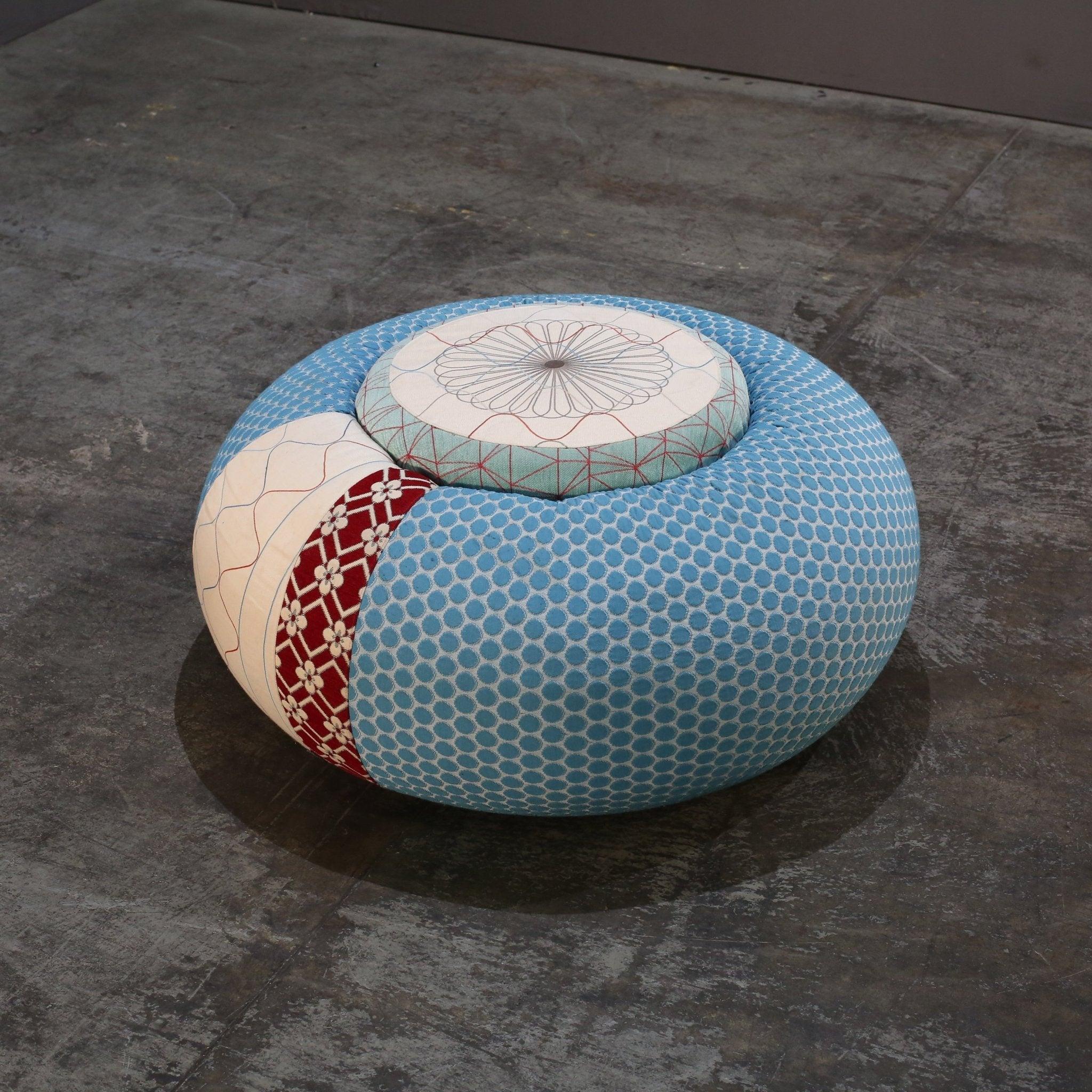 Introducing the Donut Pouf by Edward Van Vliet, a luxurious addition to any living space. This eye-catching piece features a unique donut-shaped design, adding a touch of whimsy and playfulness to your decor. Crafted by renowned Italian furniture