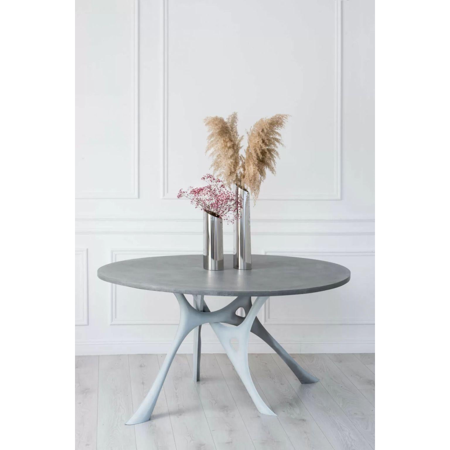Morph, Thermometallized Steel and Concrete Table by Zieta
Dimensions: D 120 x W 150 x H 74 cm.
Materials: Thermometallized Stainless Steel legs and Concrete top.

Interweaving interpretations of nature
The MORPH table takes inspiration from the