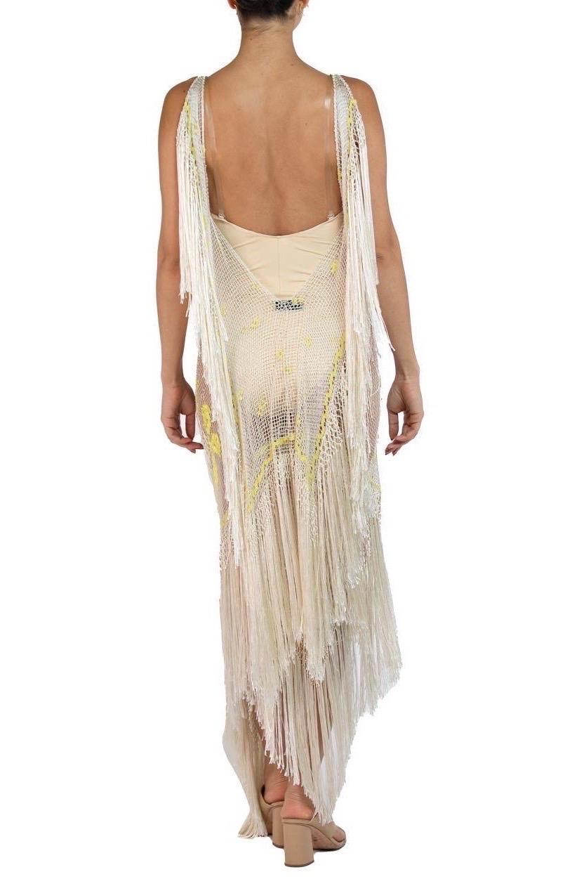 This dress is made from a 100 year old hand worked net with embroidered roses and dripping in fringe. The nature of the net has a lot of give and thus this dress will fit from a 0 to a 12 easily.  MORPHEW ATELIER Rayon & Silk Hand Knotted Edwardian