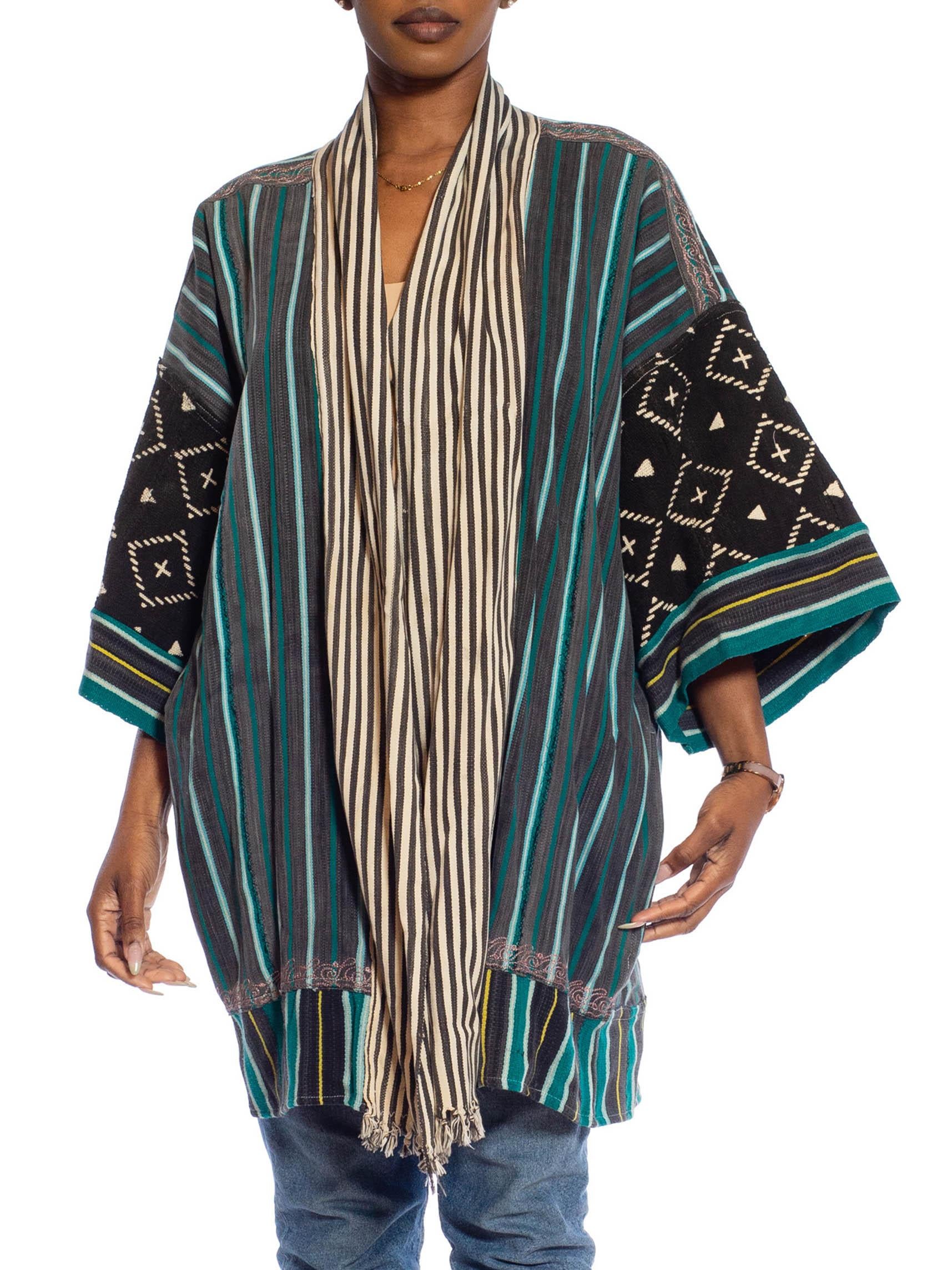 MORPHEW COLLECTION Black, Teal & Grey African Cotton Indigo Stripe Black Tie-Dye Duster
MORPHEW COLLECTION is made entirely by hand in our NYC Ateliér of rare antique materials sourced from around the globe. Our sustainable vintage materials