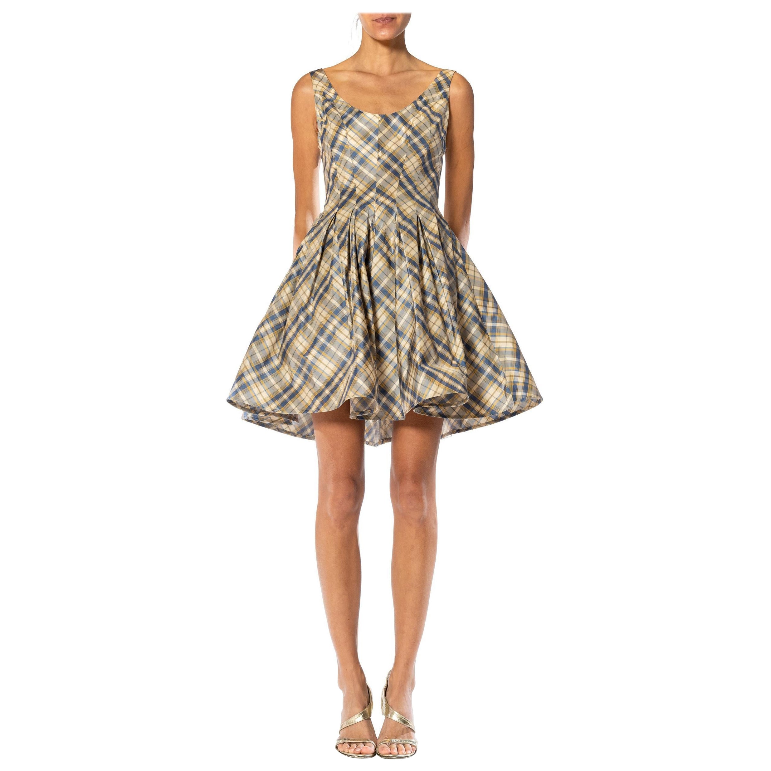 Made  from deadstock 1990s silk taffeta we scored in a closed warehouse. Cut on the bias the plaid chevrons down the body for an adorable fit and flare cut with a slight give or stretch. Finished on the hem with a wide horsehair braid to kick out