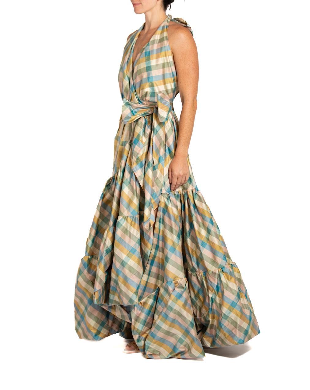 This wrap dress is made from a mixed lot of deadstock vintage 1990s silk taffeta which we discovered in an old warehouse. A limited amount of these were made  The sash ties can wrap and tie in various ways as well as it can be worn as a skirt,