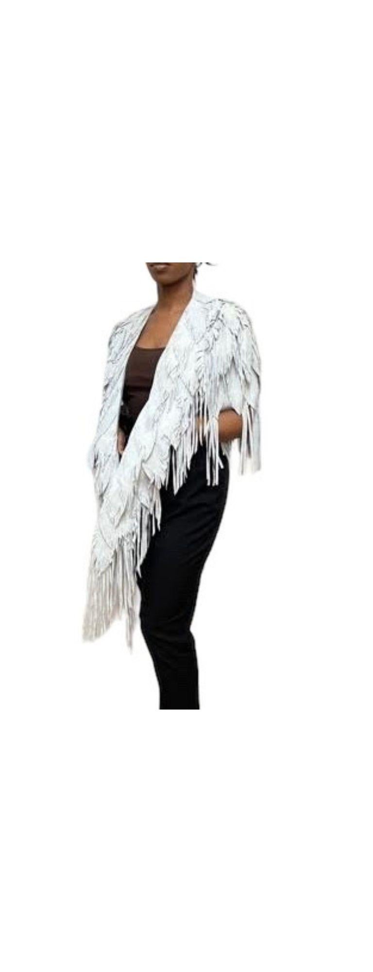 Each Feather-Leather is made by hand by our friends in Columbia in their co-op owned and operated facilities.  Morphew Collection Dove Suede Fringe Feather Leather Long Cape with two front pockets and one hidden pocket.

MORPHEW COLLECTION is made