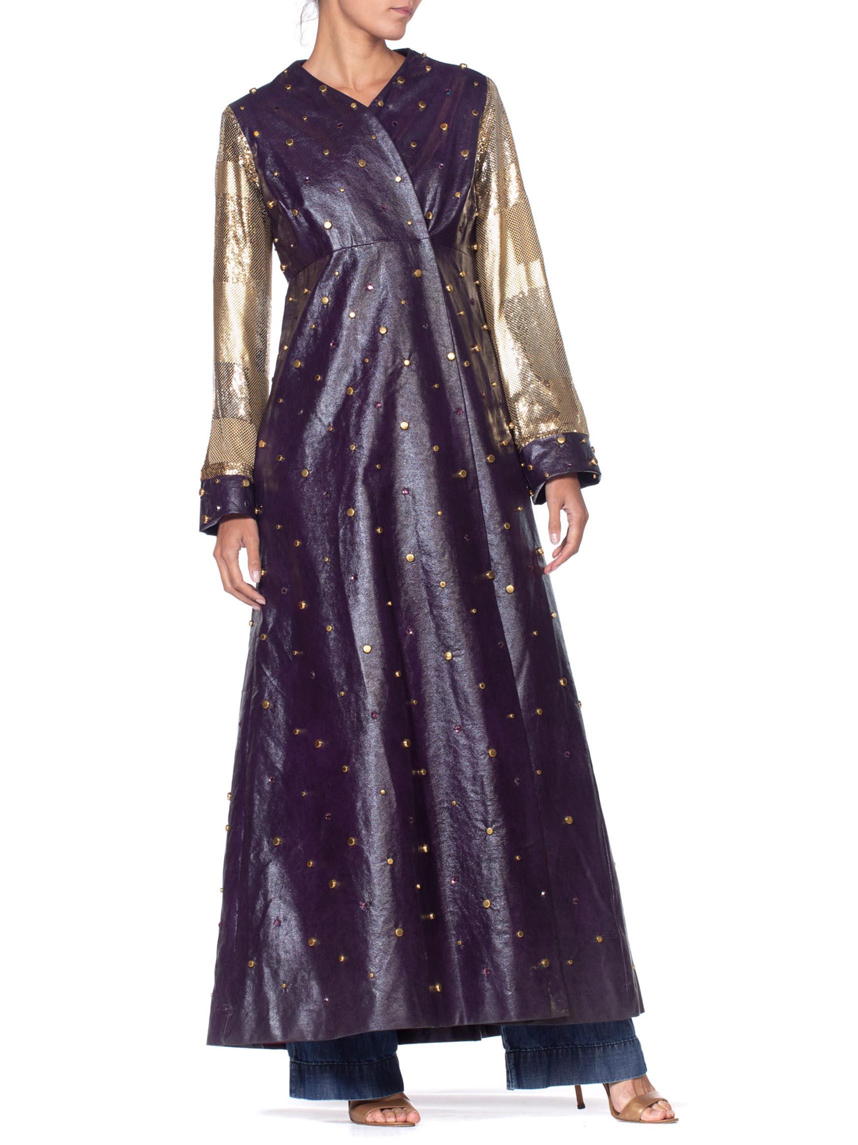 MORPHEW COLLECTION Eggplant Purple Crystal Studded Pleather Maxi Coat With Gold Metal Mesh Patchwork Sleeves
MORPHEW COLLECTION is made entirely by hand in our NYC Ateliér of rare antique materials sourced from around the globe. Our sustainable