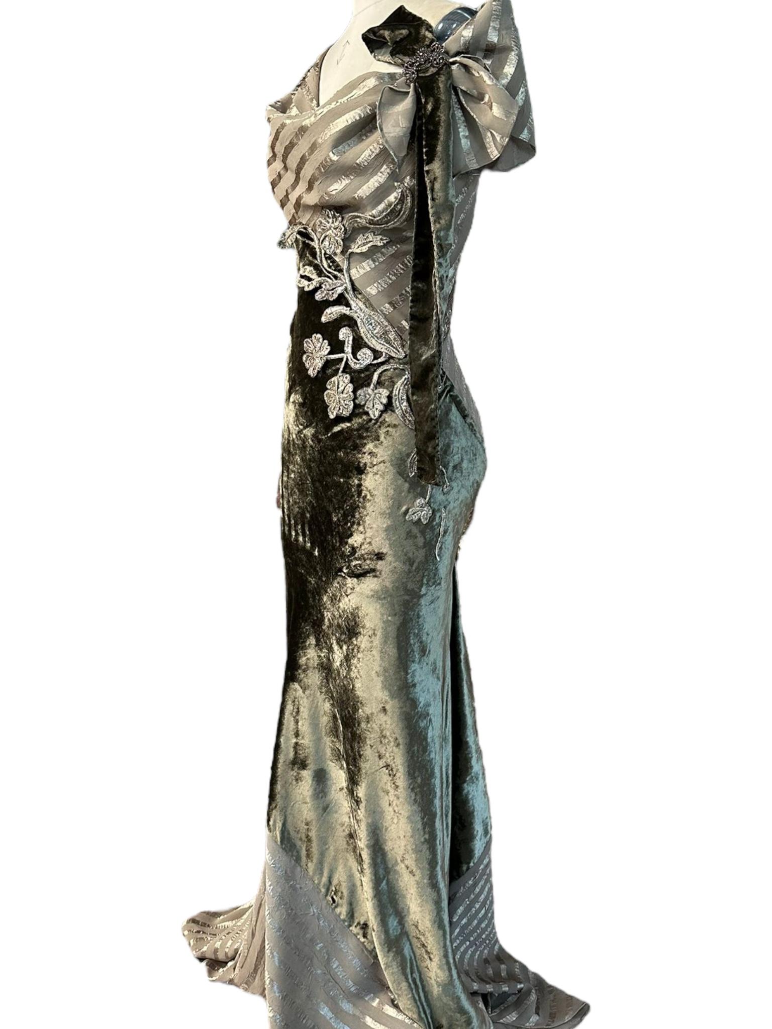 MORPHEW COLLECTION Olive Green Bias Cut Rayon Blend Velvet & Satin Striped Chiffon Gown with 18th Century Antique Silver Flowers

Material: Rayon Blend

Vintage condition: Excellent

Measurements

Overall length: 87 in.

Garment width: in.

US: S