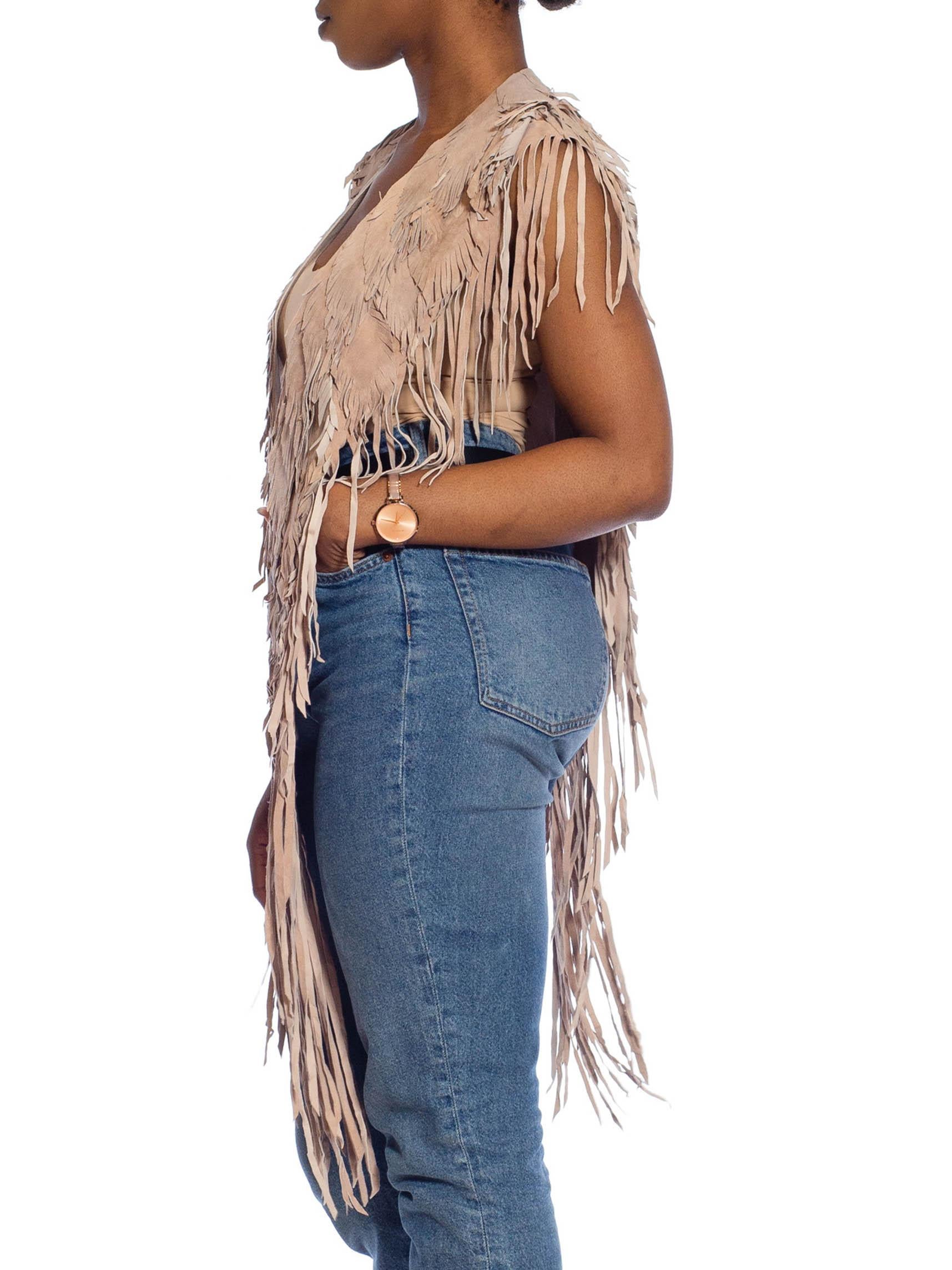 Each Feather-Leather is made by hand by our friends in Columbia in their co-op owned and operated facilities.  MORPHEW COLLECTION Sand Piper Suede Fringe Feather Leather Long Cape 
MORPHEW COLLECTION is made entirely by hand in our NYC Ateliér of