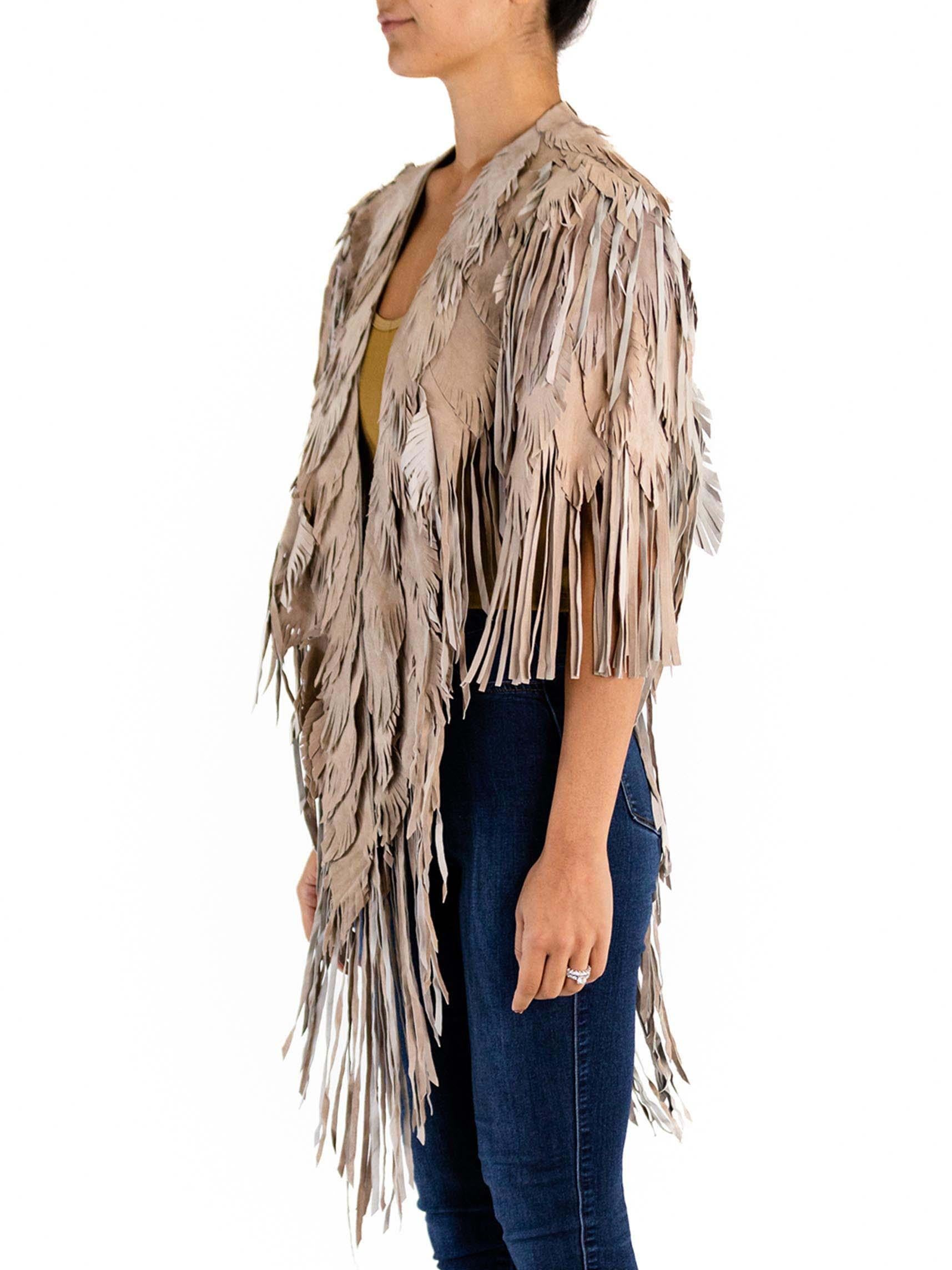 Each Feather-Leather is made by hand by our friends in Columbia in their co-op owned and operated facilities.  Morphew Collection Sand Piper Suede Fringe Feather Leather Long Cape 
MORPHEW COLLECTION is made entirely by hand in our NYC Ateliér of
