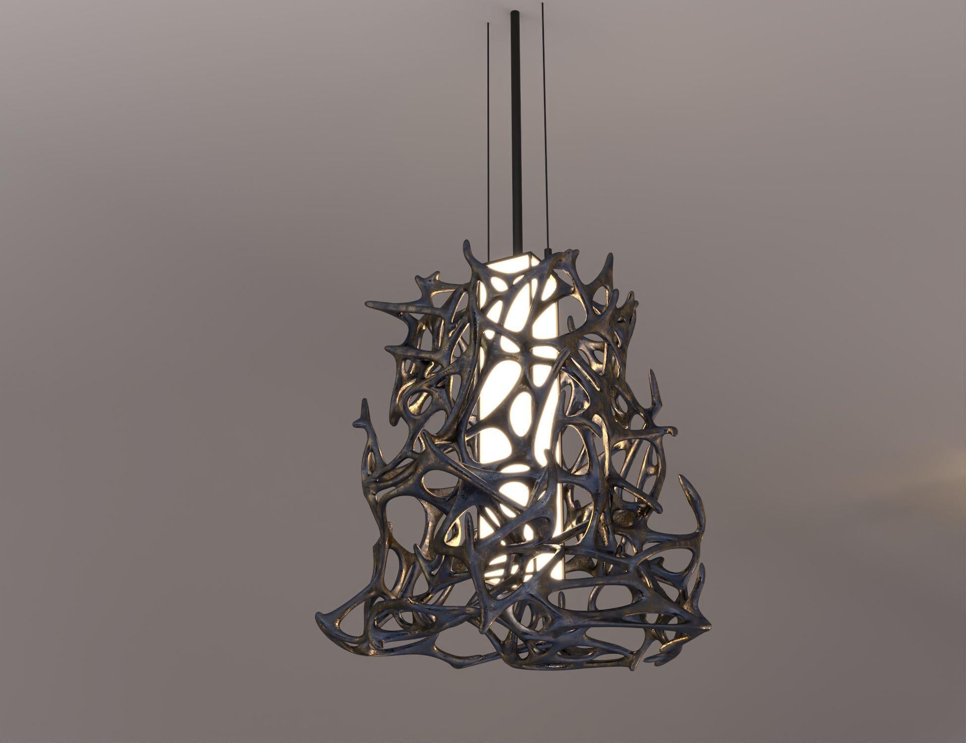 Lampada a sospensione Morphogen di John Brevards
Dimensioni: P 40,64 x L 40,64 x H 60,96 cm 
Materiali: Bronzo

Derivata dalla parola greca morphê (che significa 