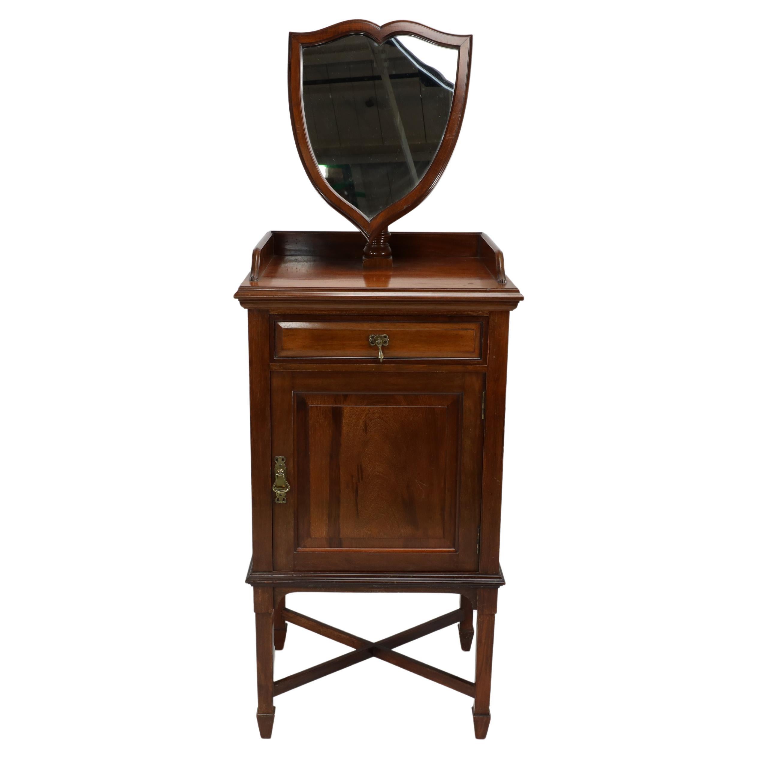 Morris and Co. A fine quality Arts & Crafts Walnut wash or shaving stand, with adjustable extending shield shaped mirror, upper drawer and cupboard lined with Sienna marble the square tapering legs with arrow head feet united by a cross stretcher.
