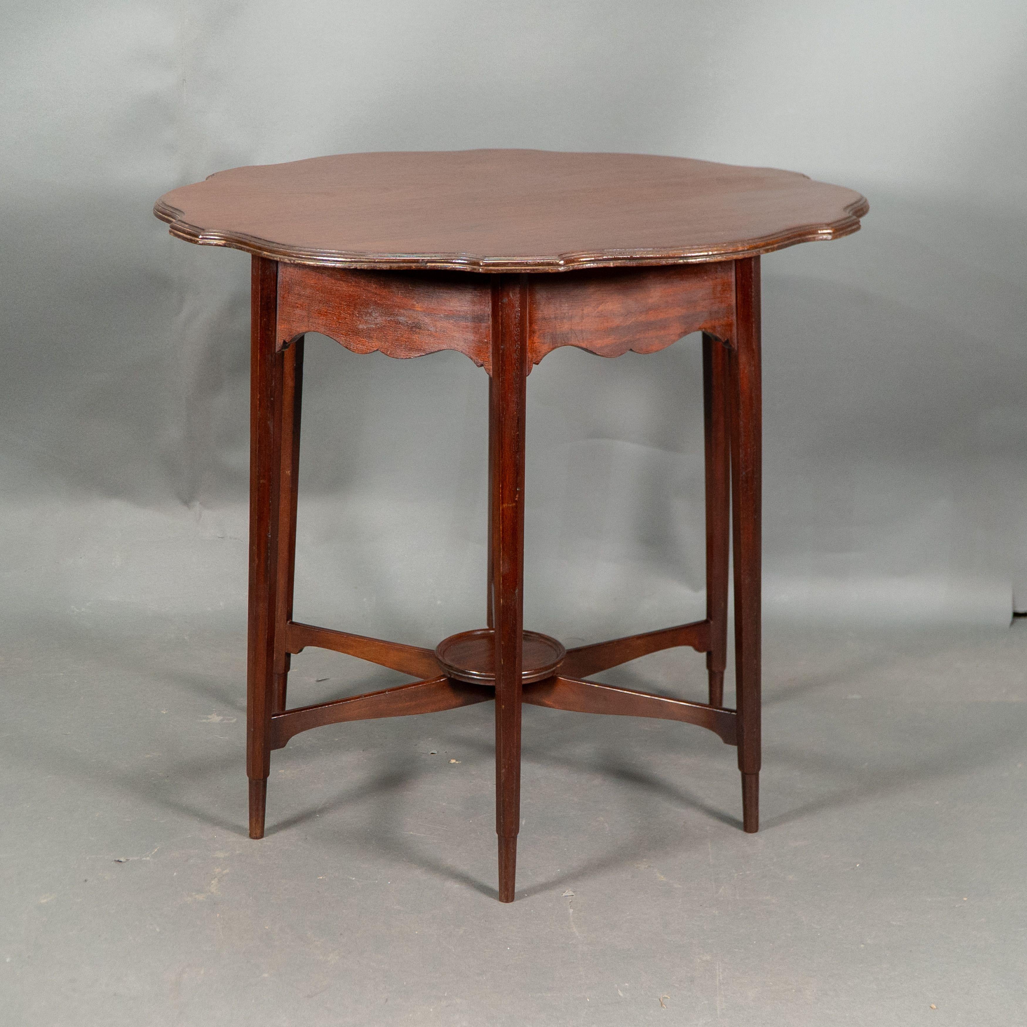 Arts and Crafts Morris and Co. Walnut side table with a shaped top and a wavey apron. For Sale
