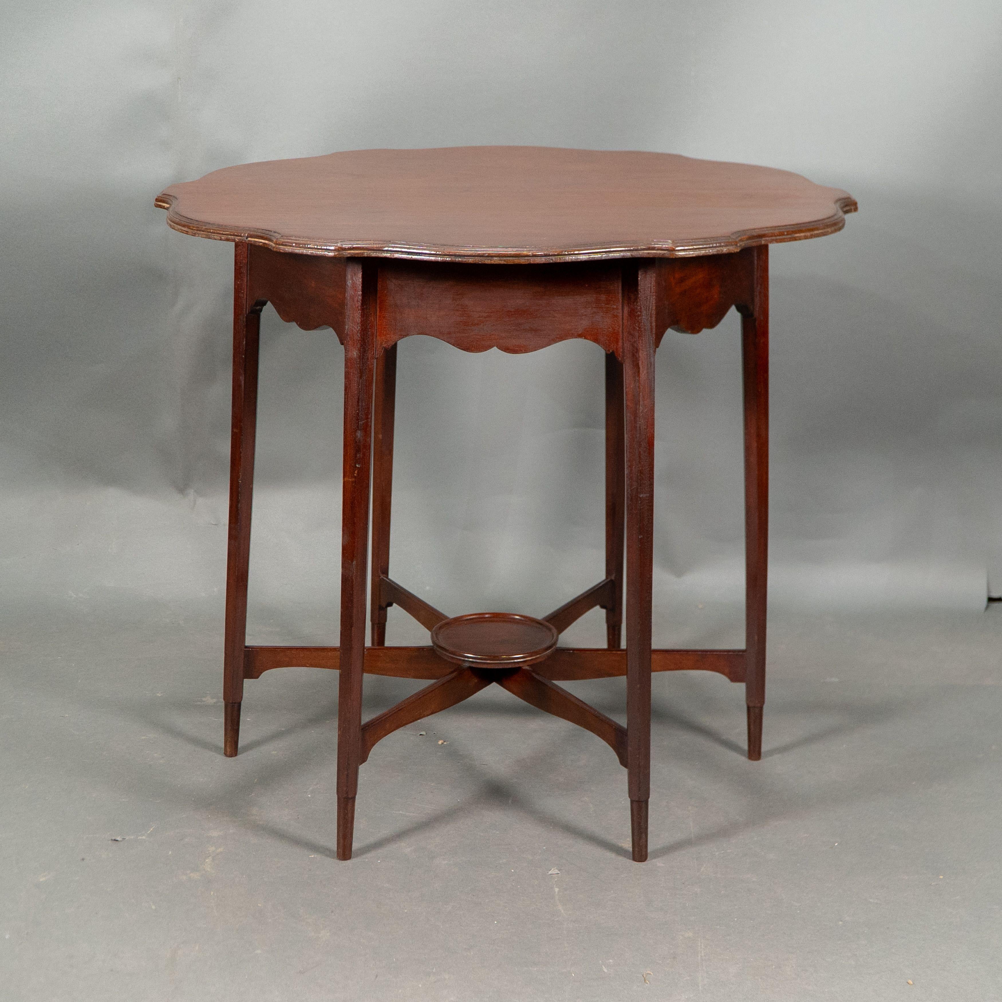 British Morris and Co. Walnut side table with a shaped top and a wavey apron. For Sale