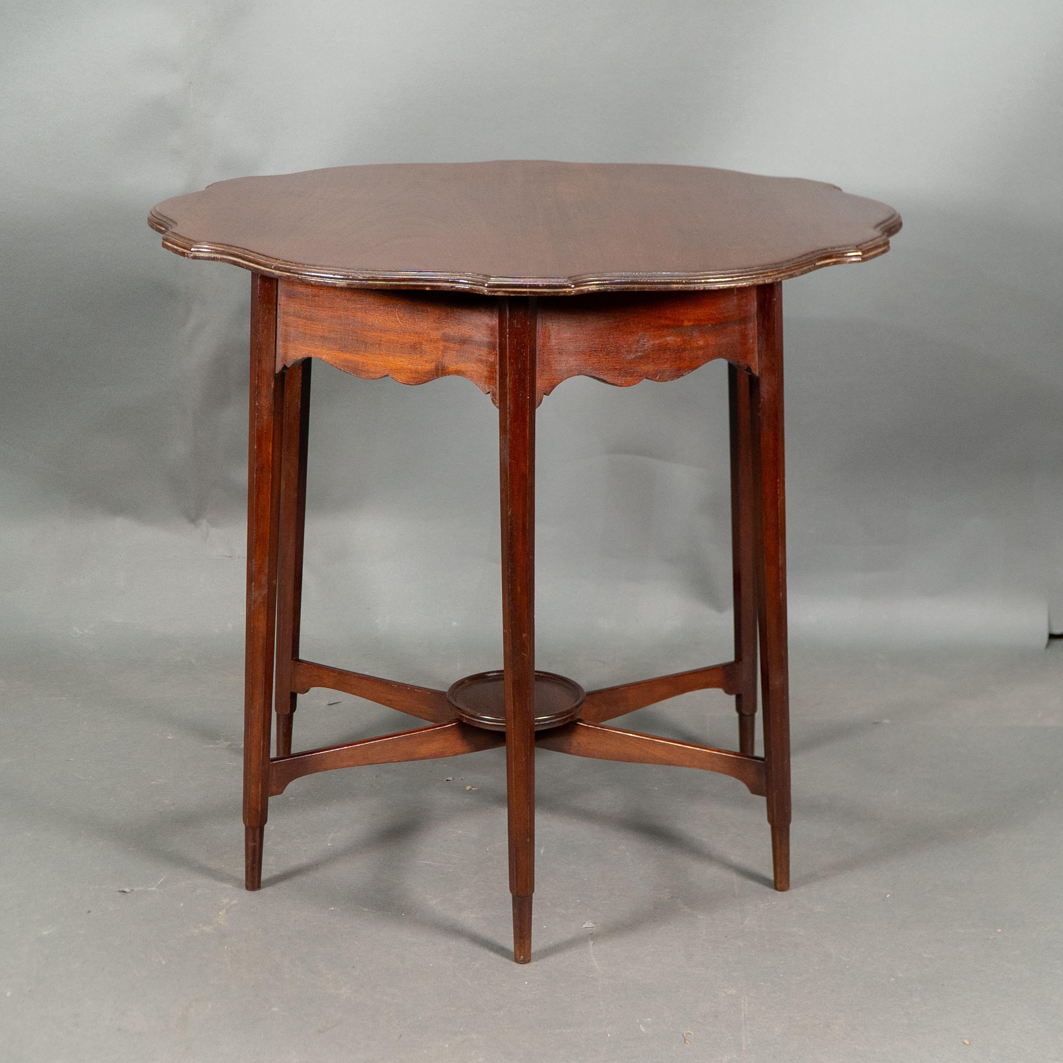 Late 19th Century Morris and Co. Walnut side table with a shaped top and a wavey apron. For Sale