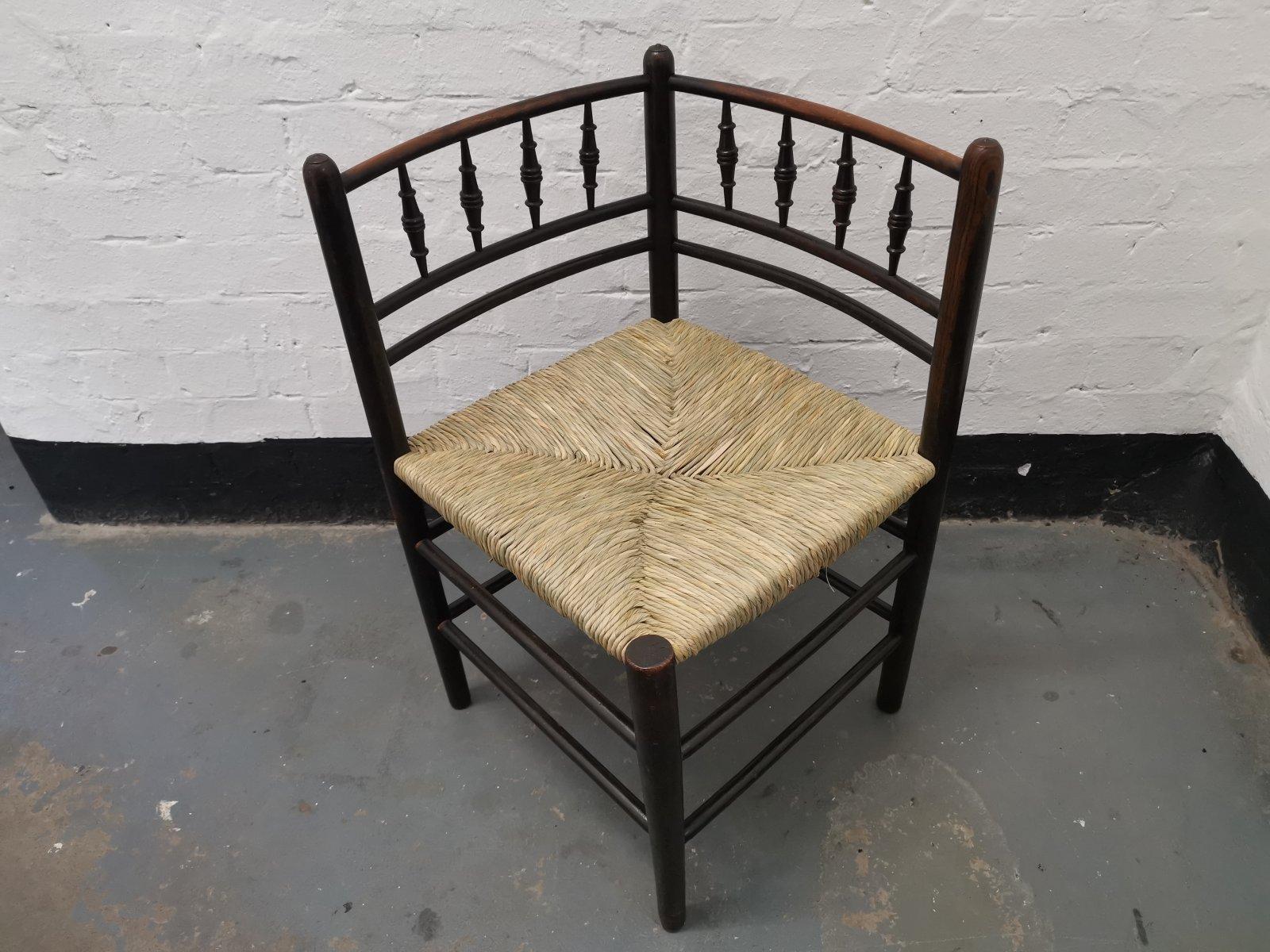 Morris & Co, Attributed to Phillip Webb. 
A Rare English Sussex, rush seat corner chair with subtly curved armrests and the classic Morris bobbin turned details to the backs.
The chair has been fully restored and professionally re rushed.