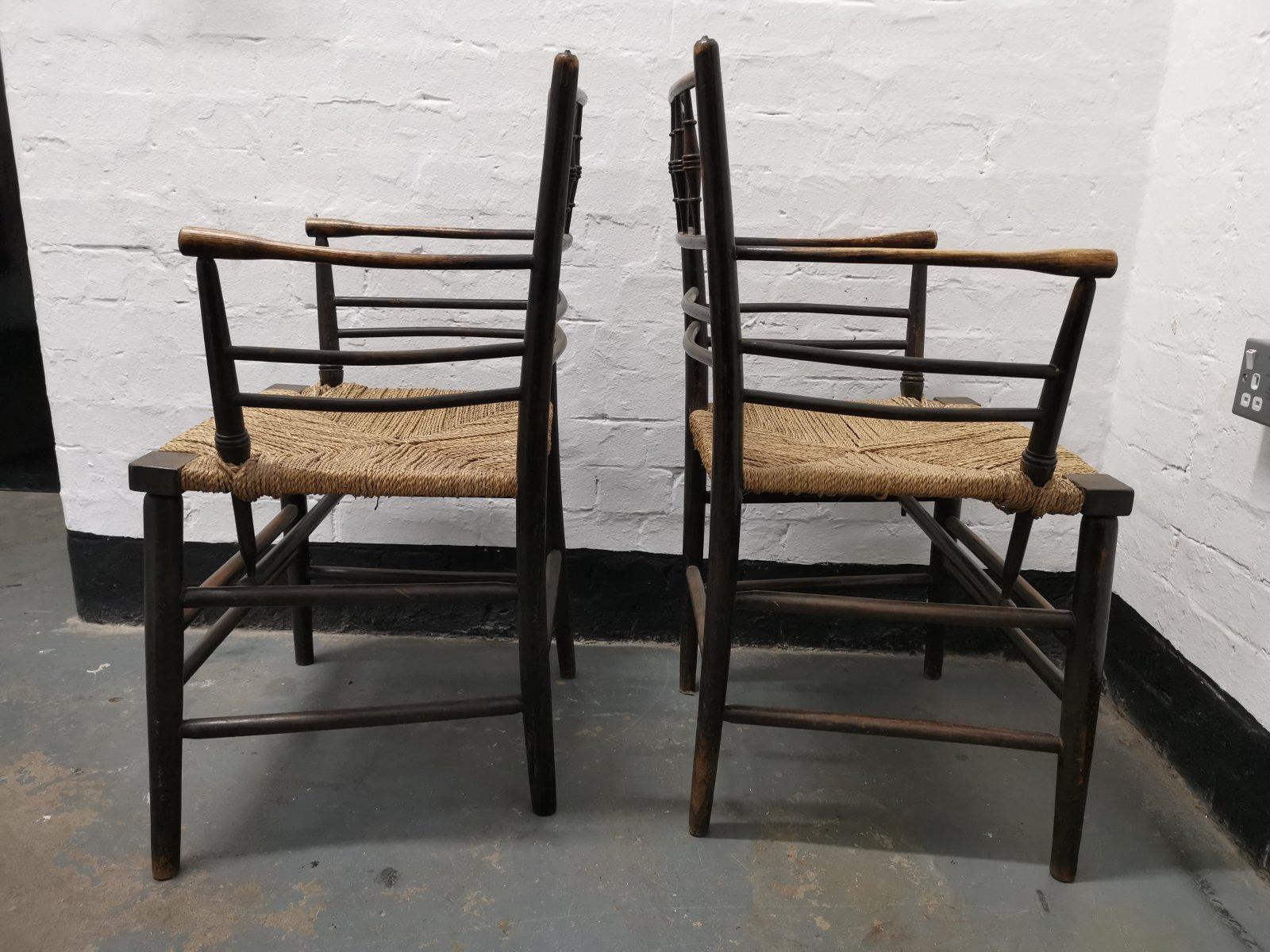 Philip Webb for Morris & Co. Sussex Range.
A classic pair of English Arts & Crafts ebonized armchairs with the original seagrass seats in great condition. 
These are a true pair, born together.

Quote : Of all the specific minor improvements in