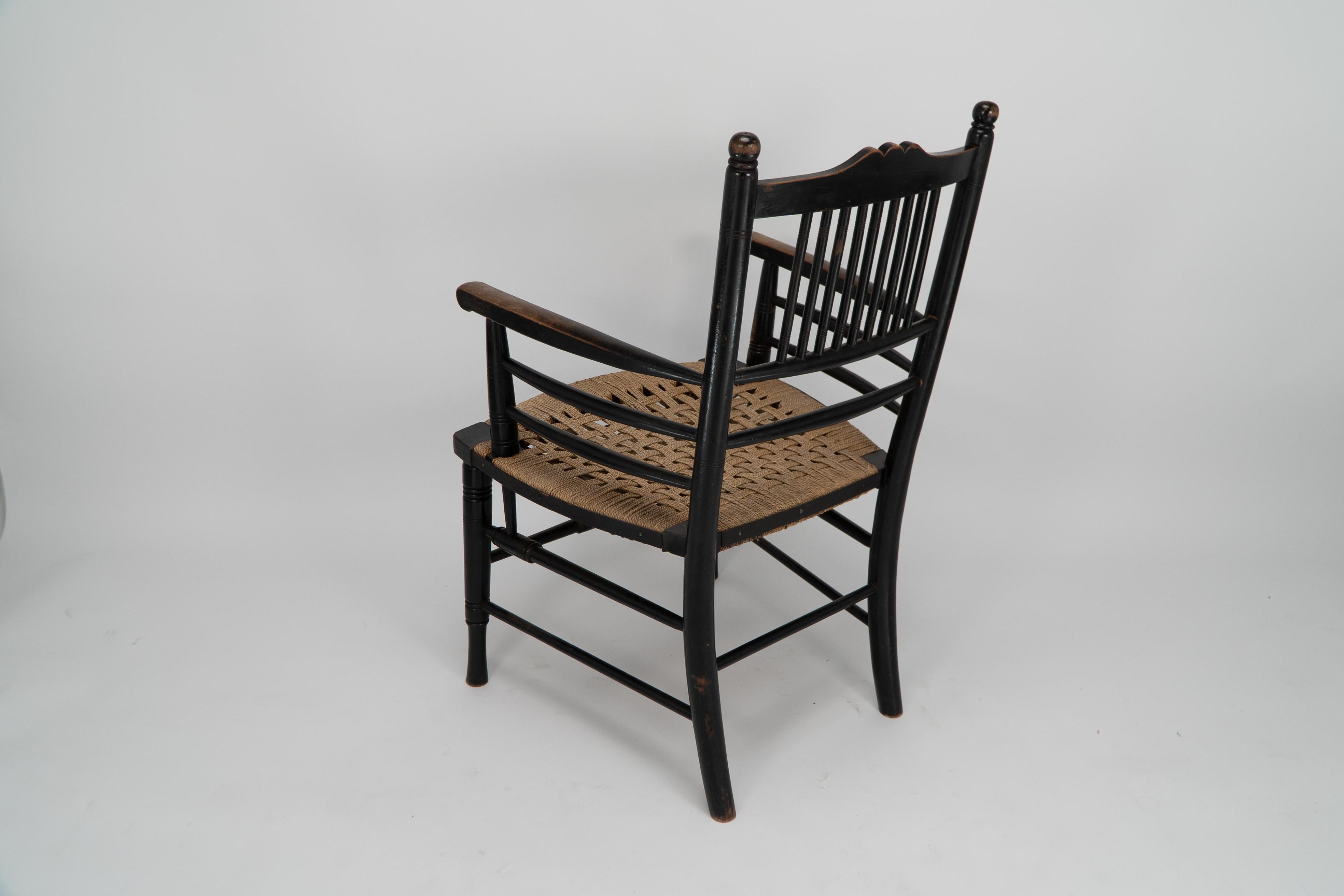 English Morris & Co (style of). An Aesthetic Movement armchair with seagrass seat For Sale