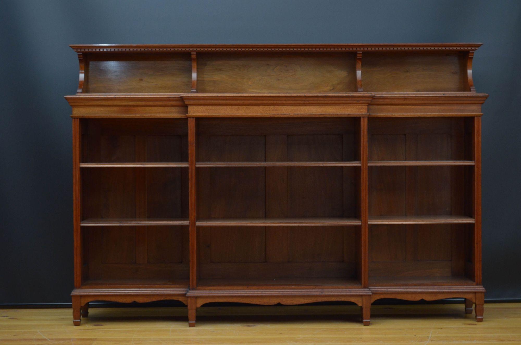 R038 Fine quality late Victorian / Arts and Crafts walnut bookcase by Morris & Co, having upstand to the back, dentil decoration above figured walnut top and projecting centre section flanked by two open section, all fitted with height adjustable