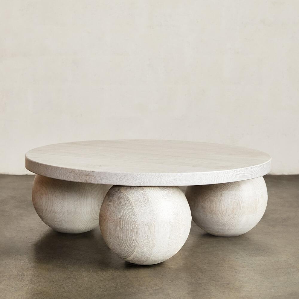 Hand carved from solid stone, the Morro Coffee Table exemplifies modernity through geometric simplicity and form. The sculptural 3-sphere base and substantial top are each composed of solid Coulmier Limestone with a honed finish that enhances the