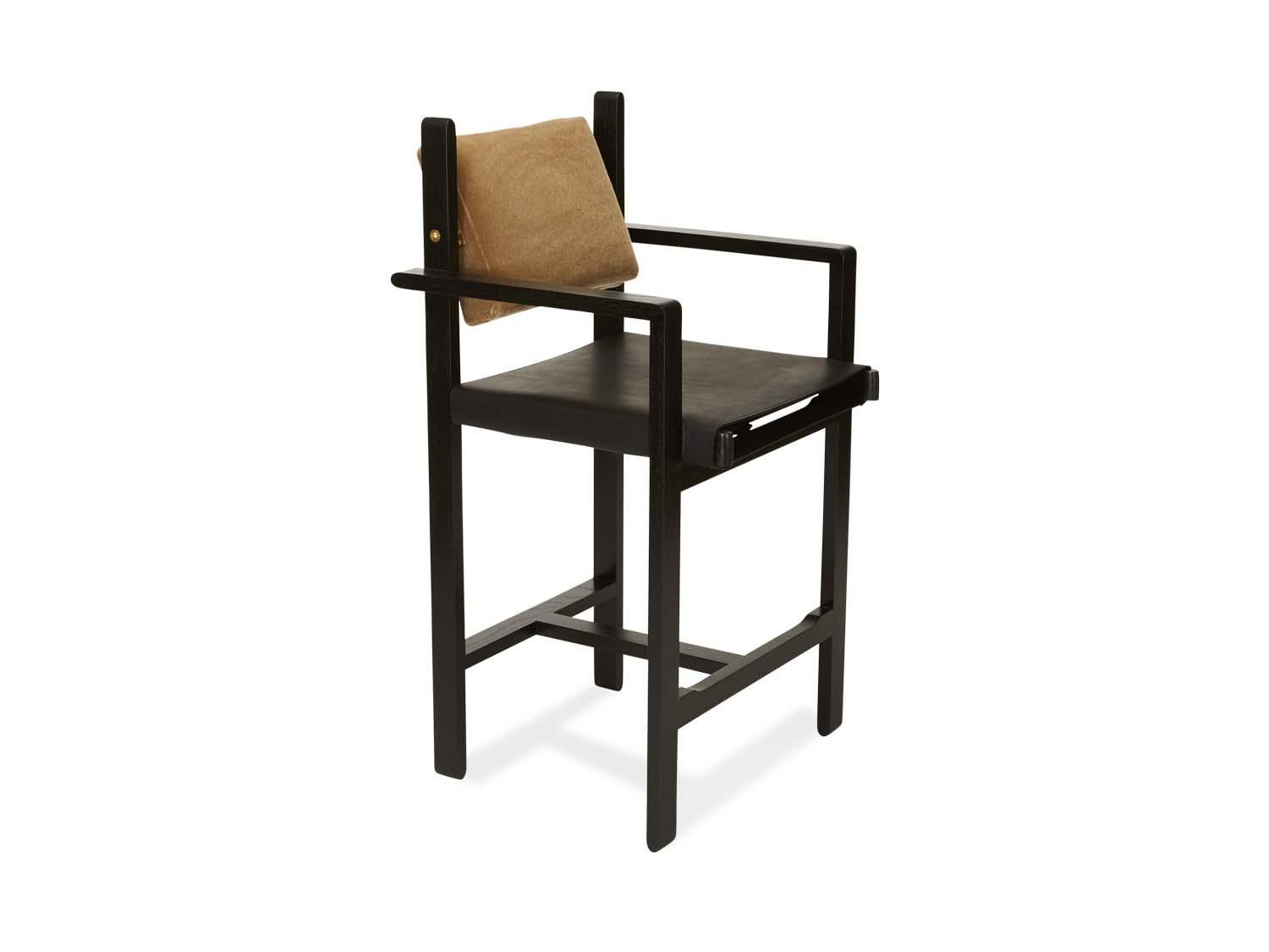 The Morro barstool is made from a solid walnut or oak frame and features an upholstered back cushion and a leather sling seat. An optional loose seat cushion is also available. Inspired by the articulated connections of Bauhaus
