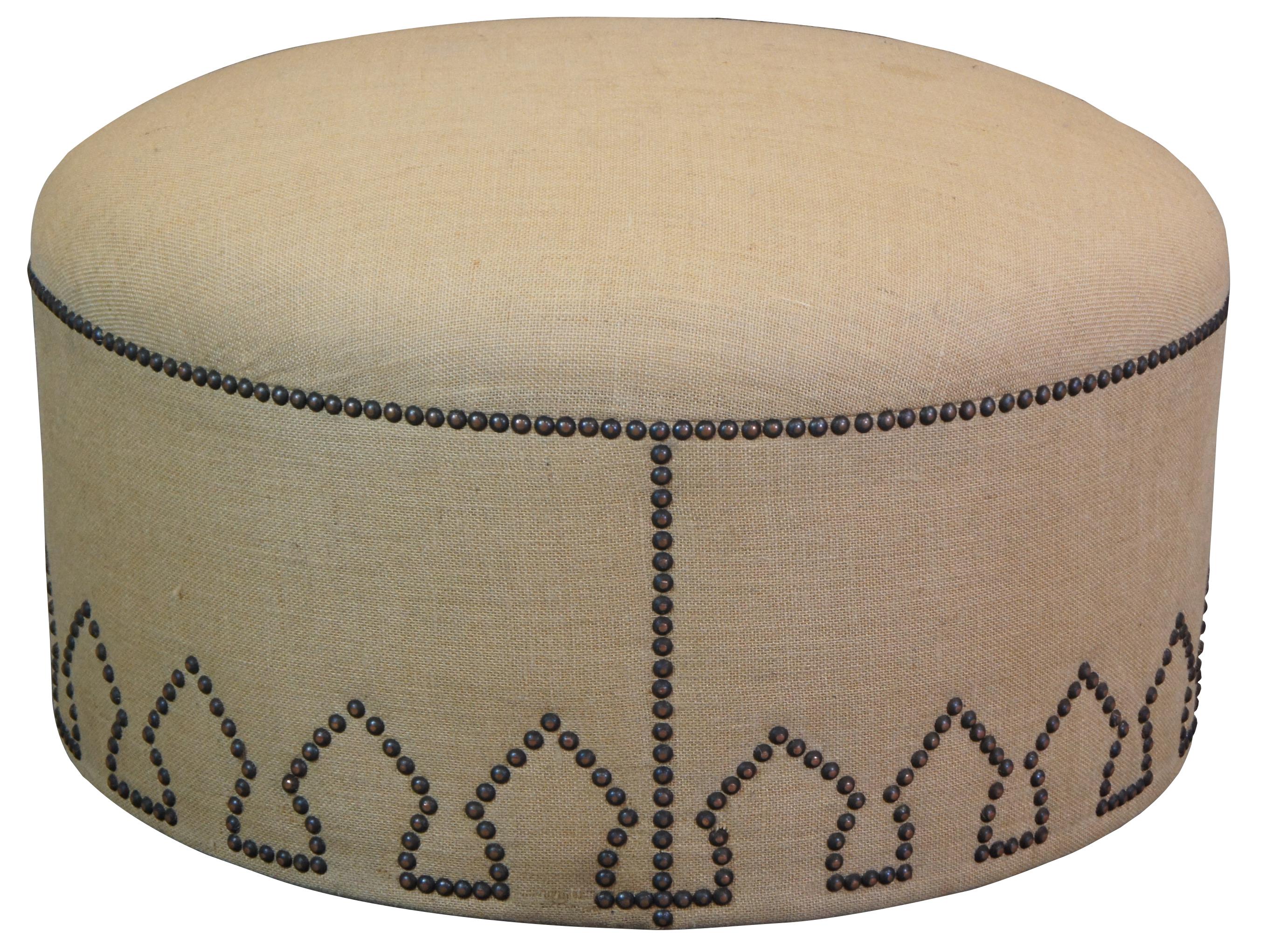 Vintage burlap ottoman, foot rest or stool featuring morrocan styling with round form and nailhead accents.
    