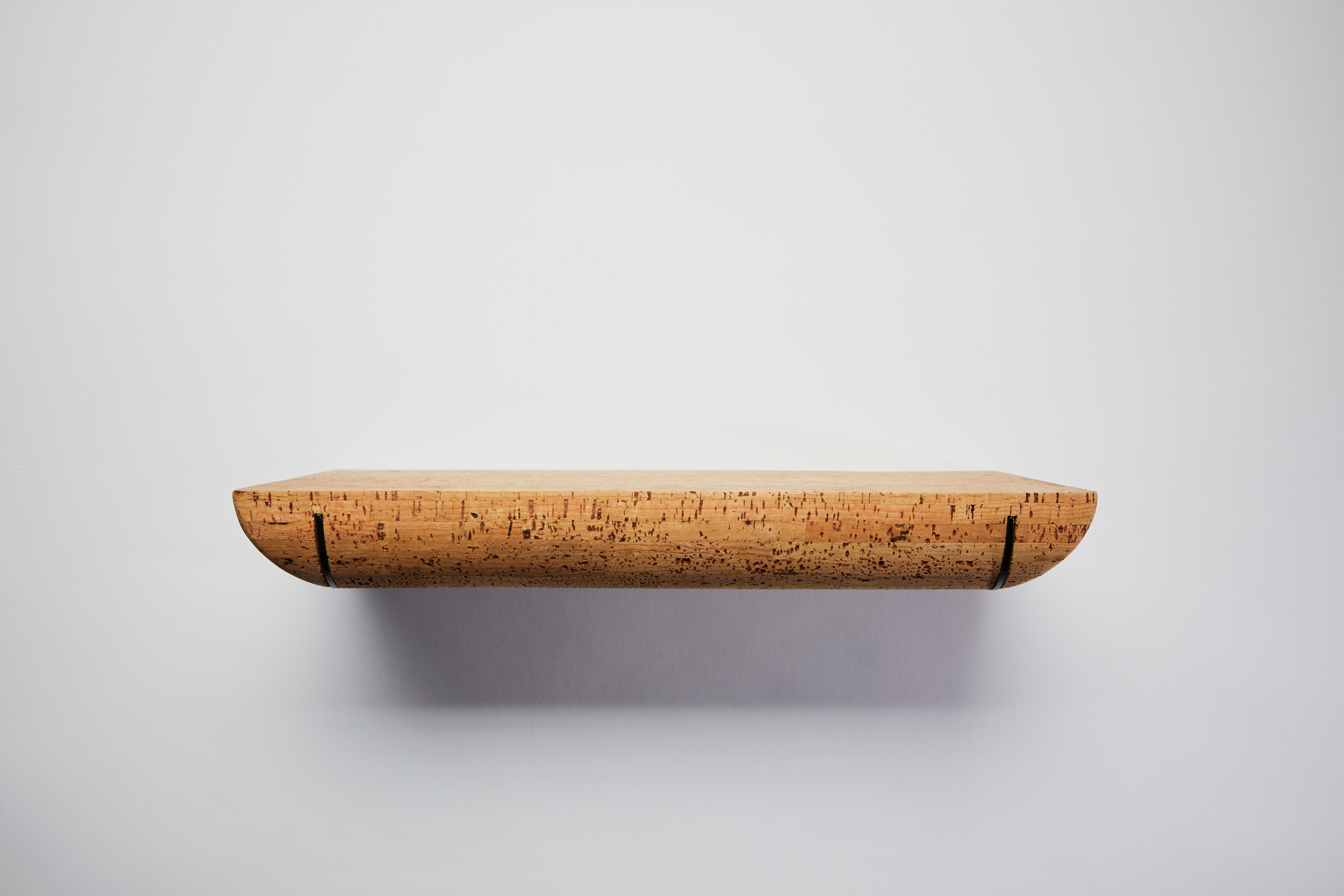 Mortaise wall shelf-400 by Clemence Birot
Dimensions: 40 x 25 x 6,5 cm
Materials: cork, metal.

Clemence Birot started her career in Copenhagen, Denmark, and discovered a design practice closely related to craftsmanship. The latter plays an