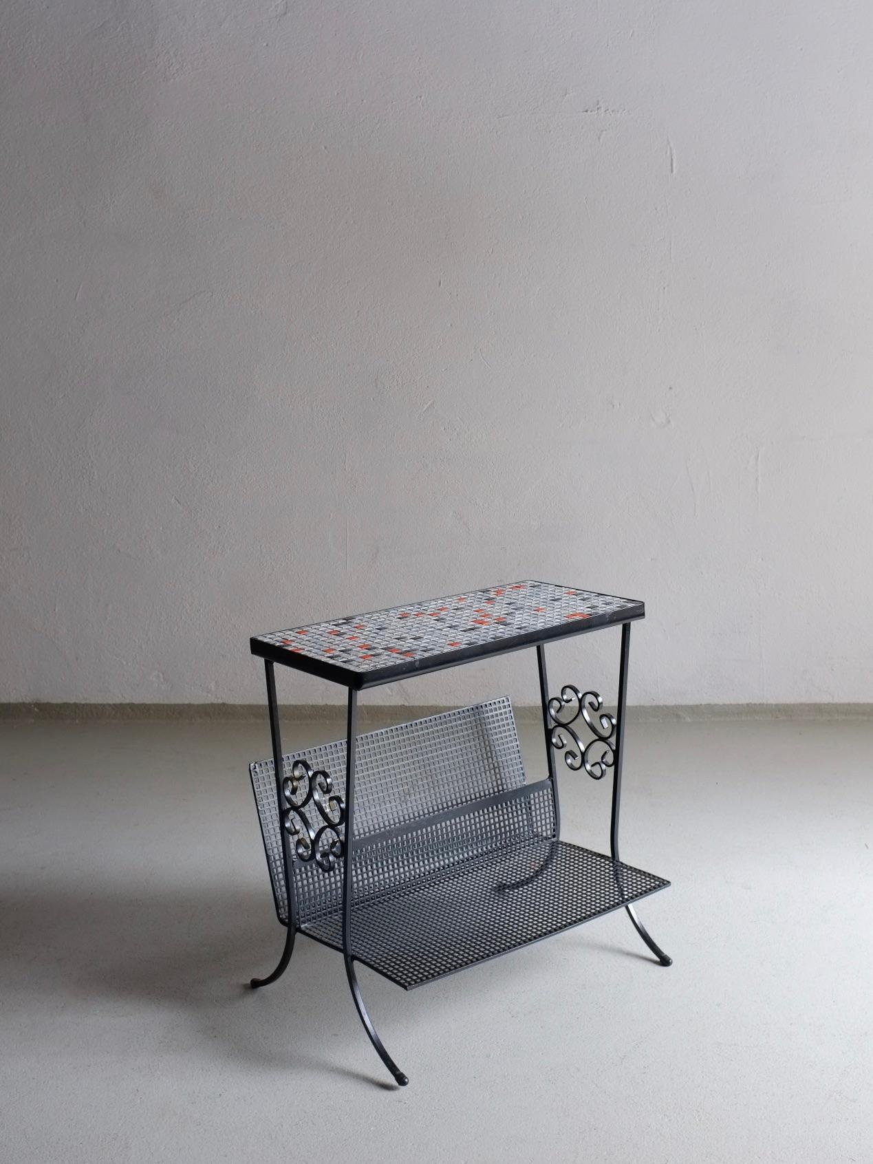 Vintage metal magazine holder with mosaic ceramic tiles tabletop.

Additional information:
Country of manufacture: France
Design period: 1950s
Dimensions: 42 W x 30 D x 42 H cm
Condition: Good vintage condition (some signs of use on metal)