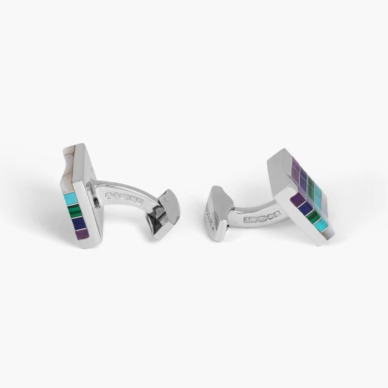 Mosaic City Line Rectangular Cufflinks in Blue Tones

A semi-precious stone is flush inlaid with mosaic stripes of silver and has a carved groove area in the centre of these rectangular cufflinks. Five different stones have been incorporated within