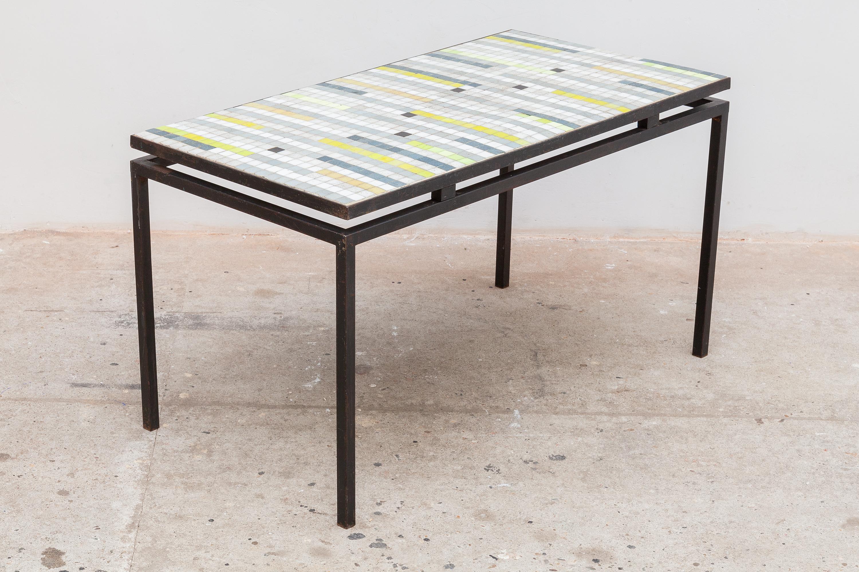 Vintage midcentury mosaic tile table. Striped design with neutral stone tile striped with blues and neon yellow. Floating iron frame.
Dimensions: 91 W x 50 H x 47 D cm.