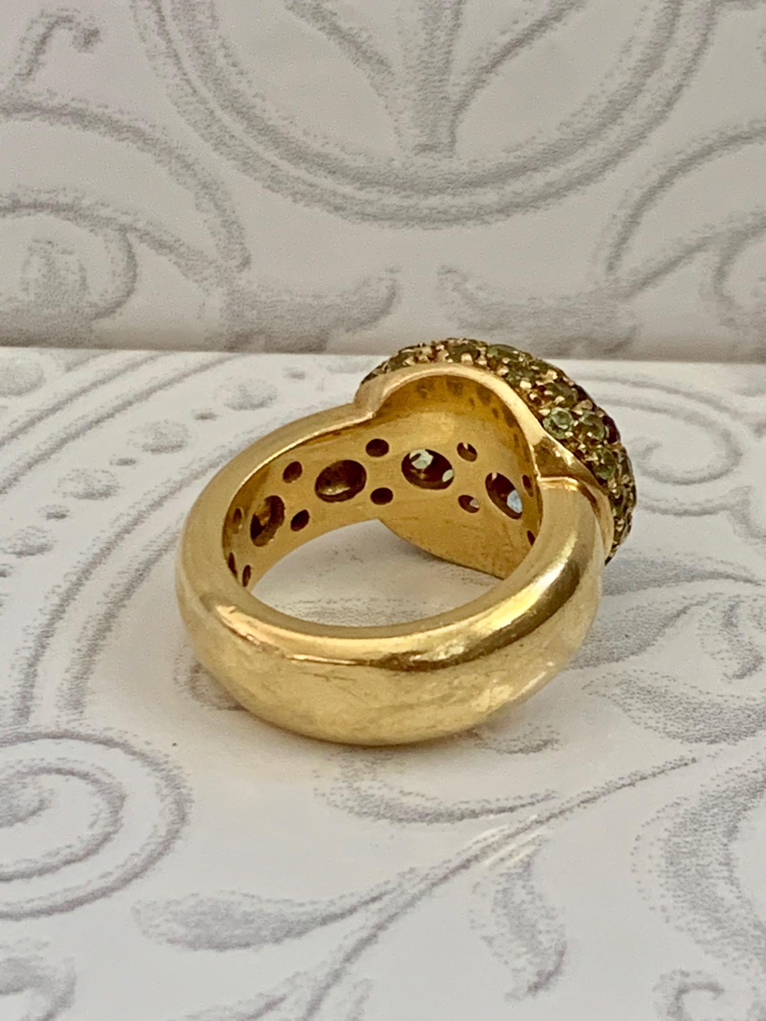 SUCH A PRETTY MULTI-COLOR, SUMMER FLOWER RING
This 18k yellow gold  Fashion ring has a comfortable wide yellow gold band  
domed Flower design which contains 2.5mm round faceted stones including: Peridot, Amethyst, Citrine, Pink Tourmaline and Blue