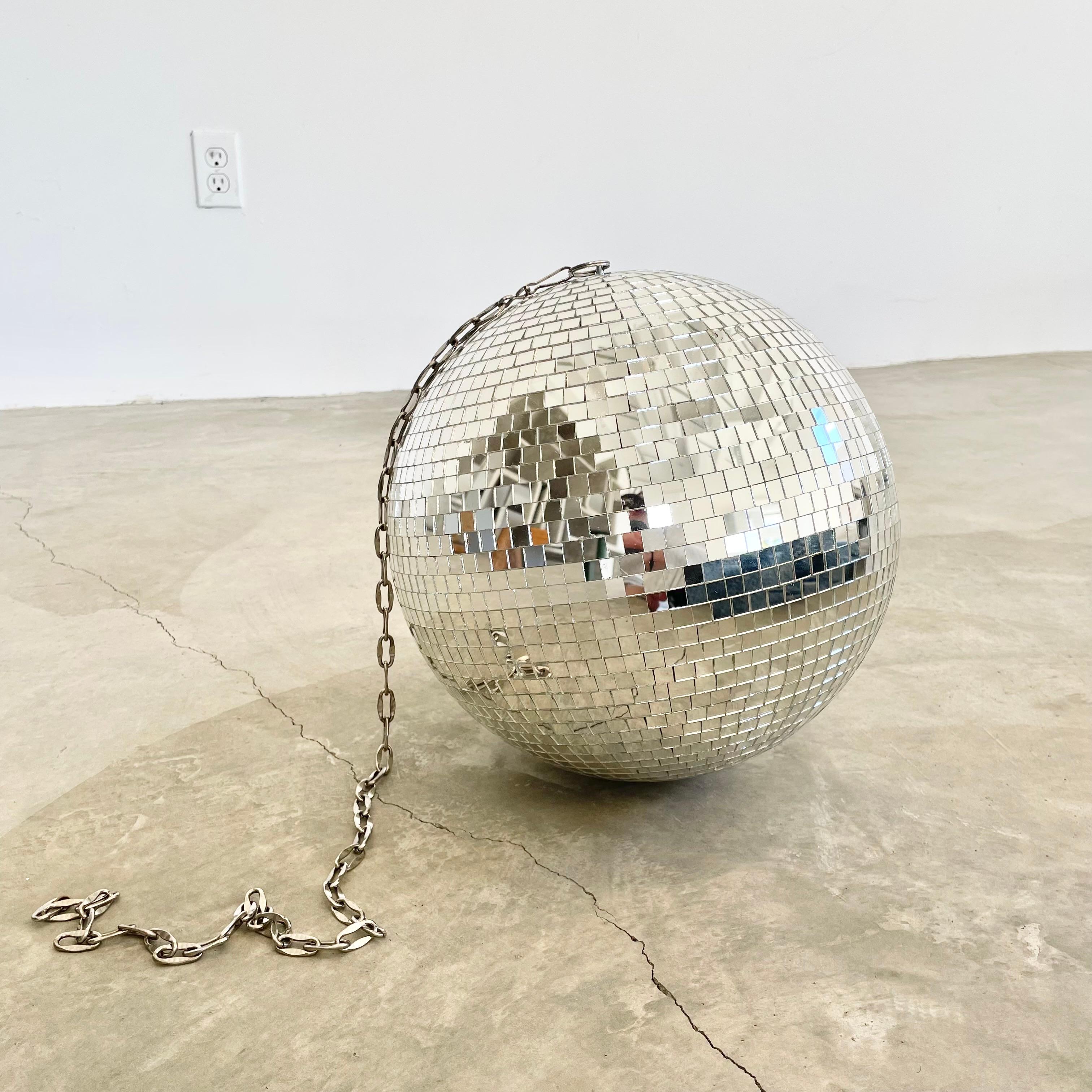 Great retro disco ball made out of individually cut square pieces of glass. Great condition. Illuminates beautifully. Has a metal ring at the top which is connected to a 3 foot long silver chain link which can be taken off if desired. Great